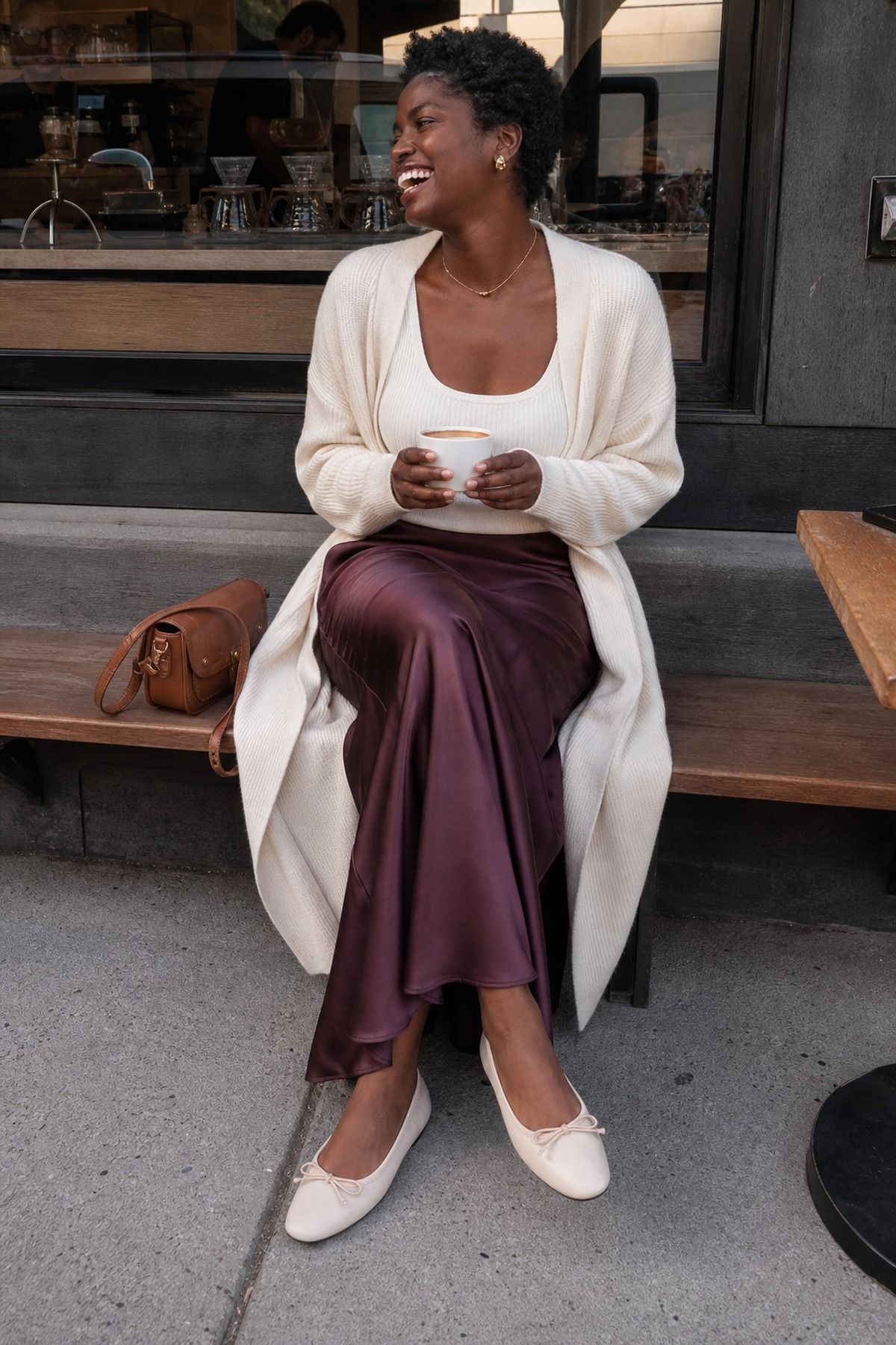 Woman wearing a satin maxi skirt with an oversized cardigan, a casual fall maxi skirt outfit