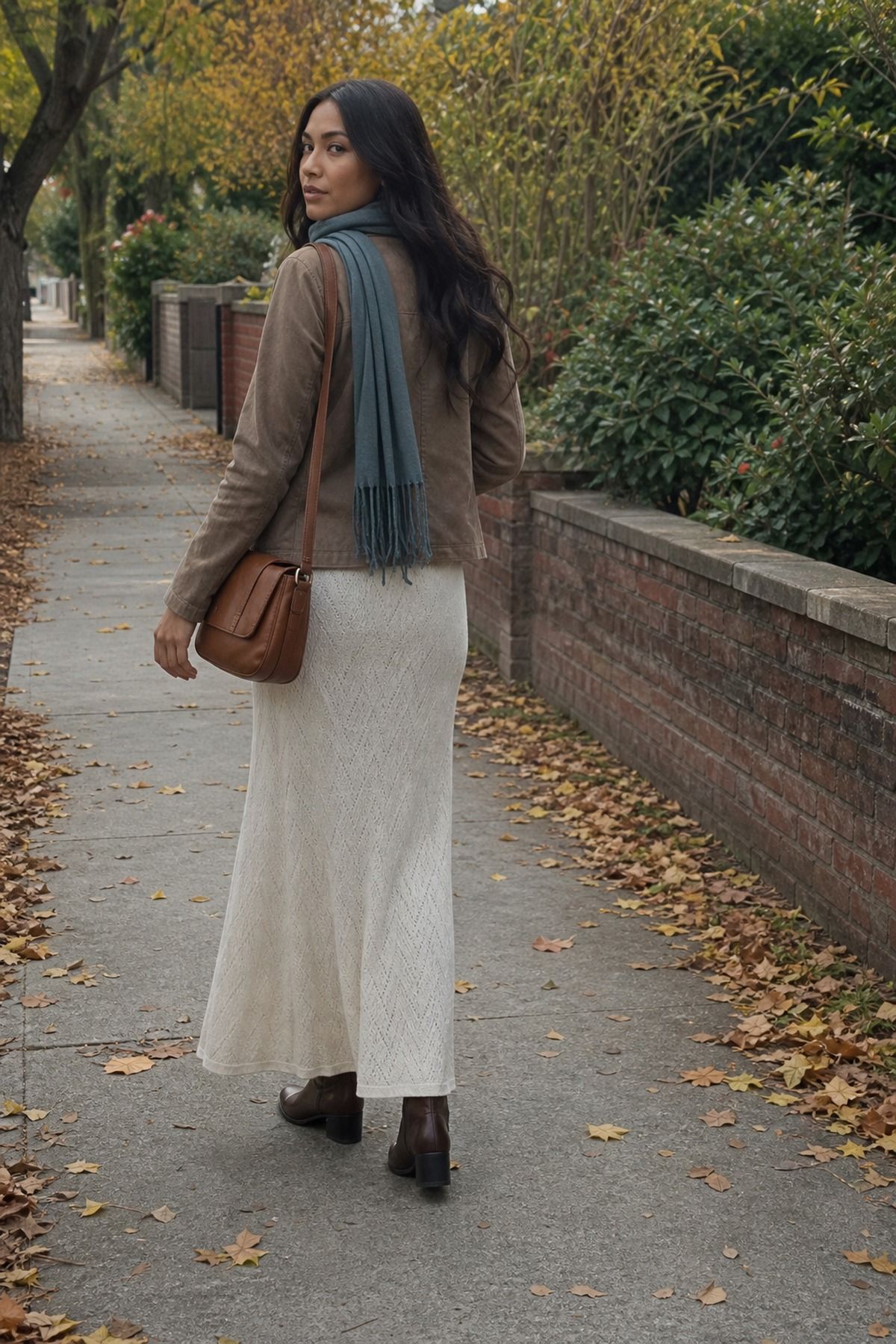 Woman wearing a maxi skirt with a suede jacket and boots, a casual fall maxi skirt outfit