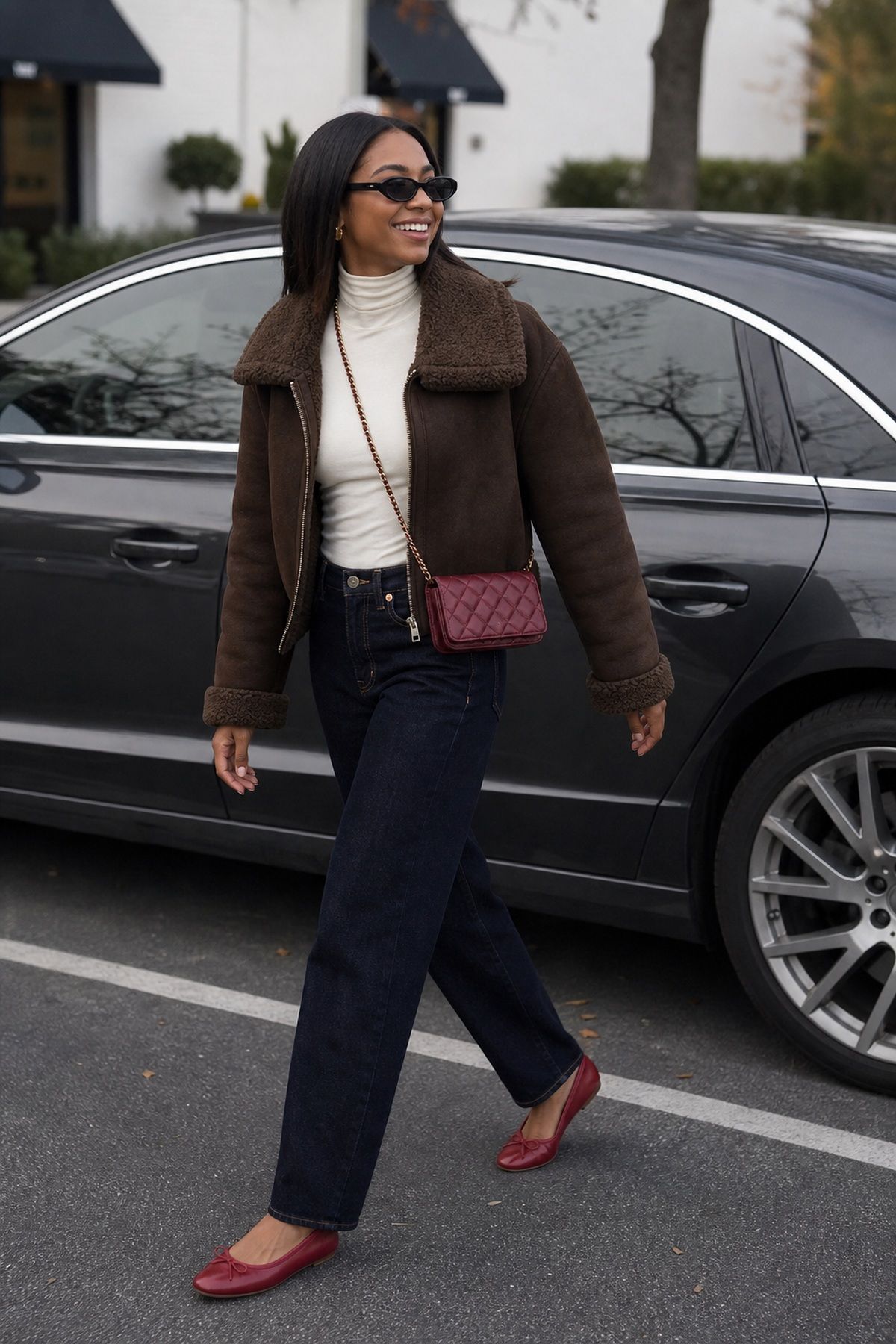 Woman wearing a shearling jacket with a slim turtleneck and dark denim, a casual fall outfit