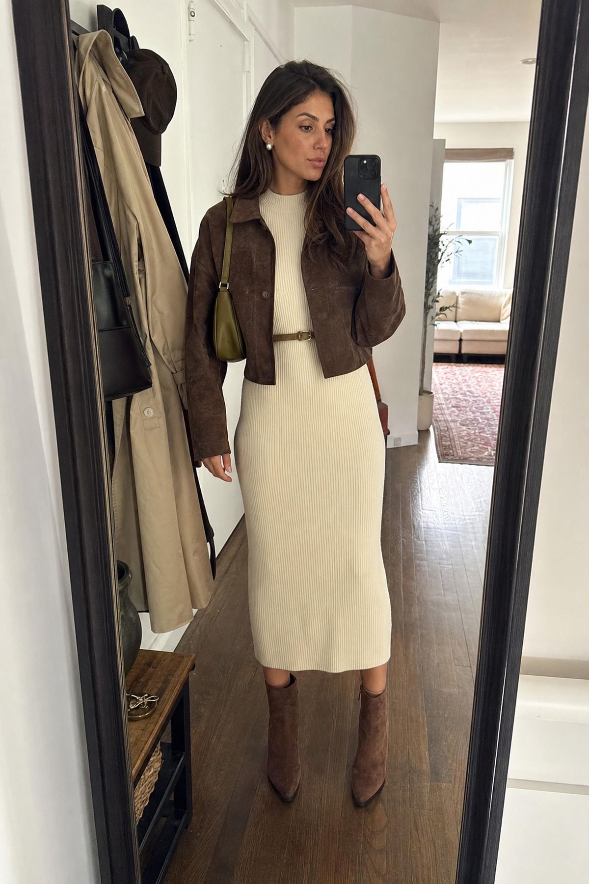 Woman wearing a sweater midi dress with ankle boots, a casual Friendsgiving outfit