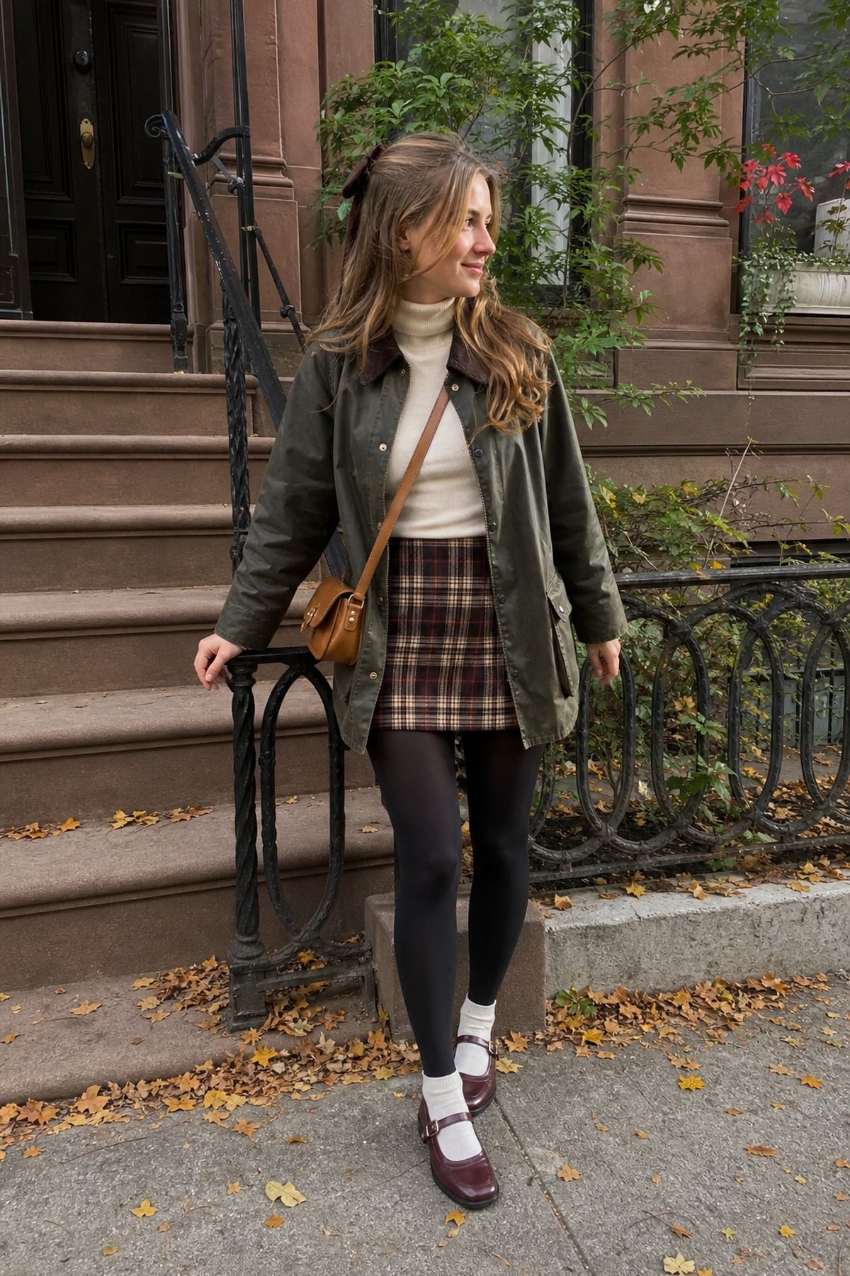 Woman wearing a barn coat over a plaid mini and tights, a casual Friendsgiving outfit