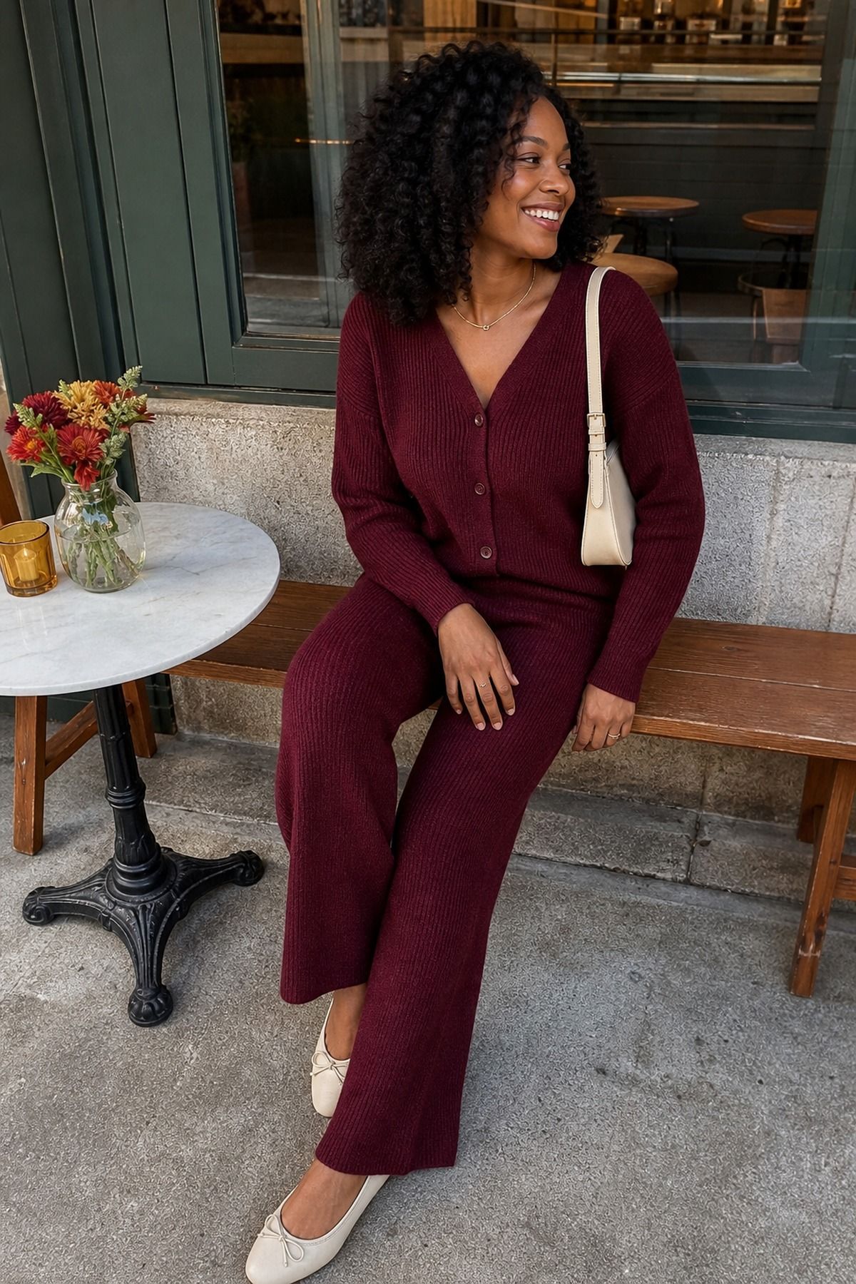 Woman wearing a cream or maroon knit set, a casual Thanksgiving outfit