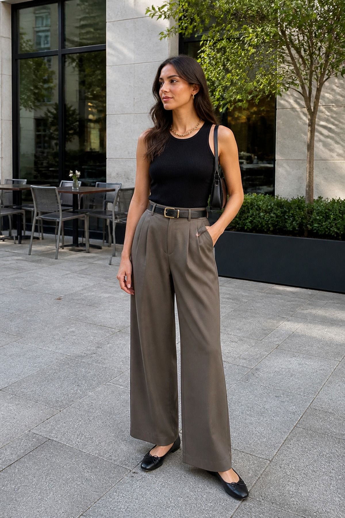 Woman wearing a black tank with wide leg trousers, an everyday outfit