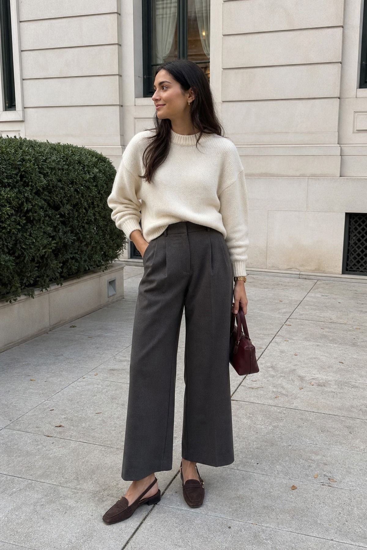 Woman wearing a crewneck sweater with wide leg trousers, an everyday outfit