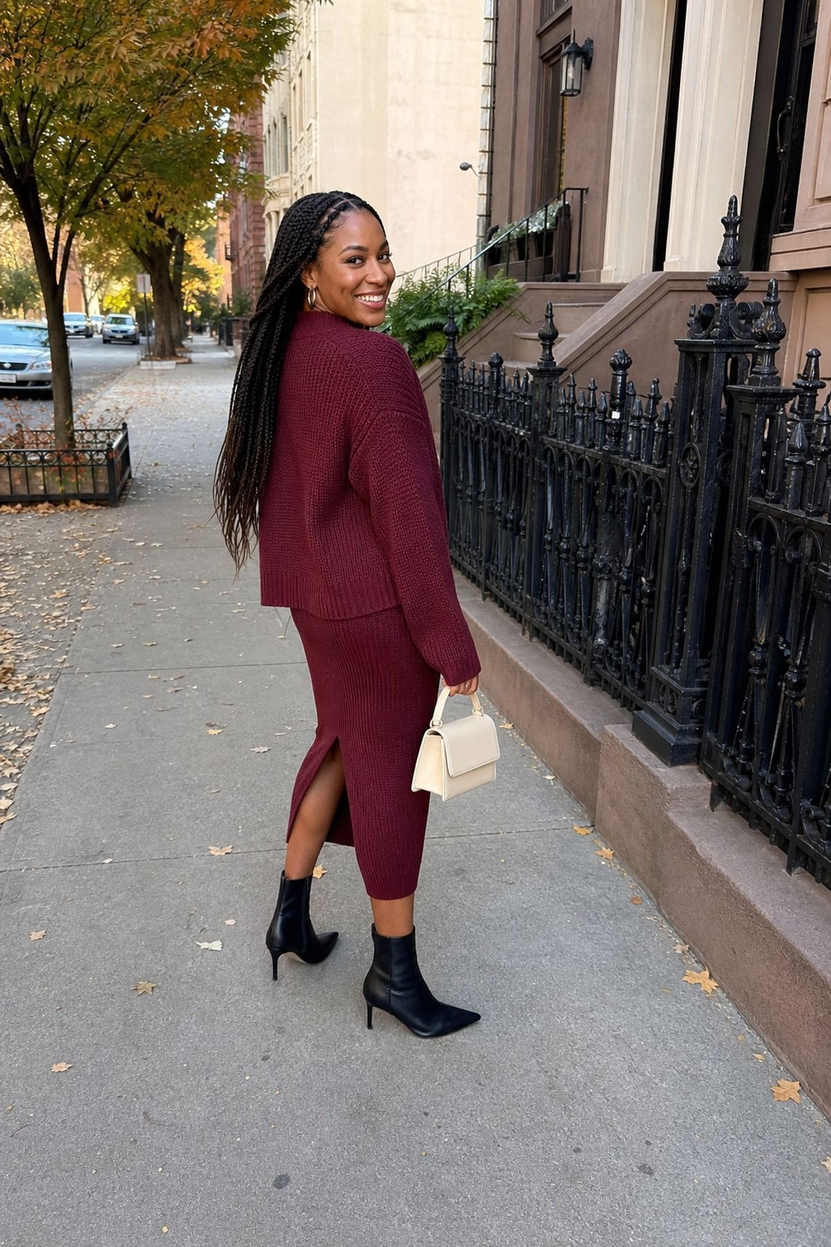 Woman wearing a maroon knit set with ankle boots, a fall brunch outfit