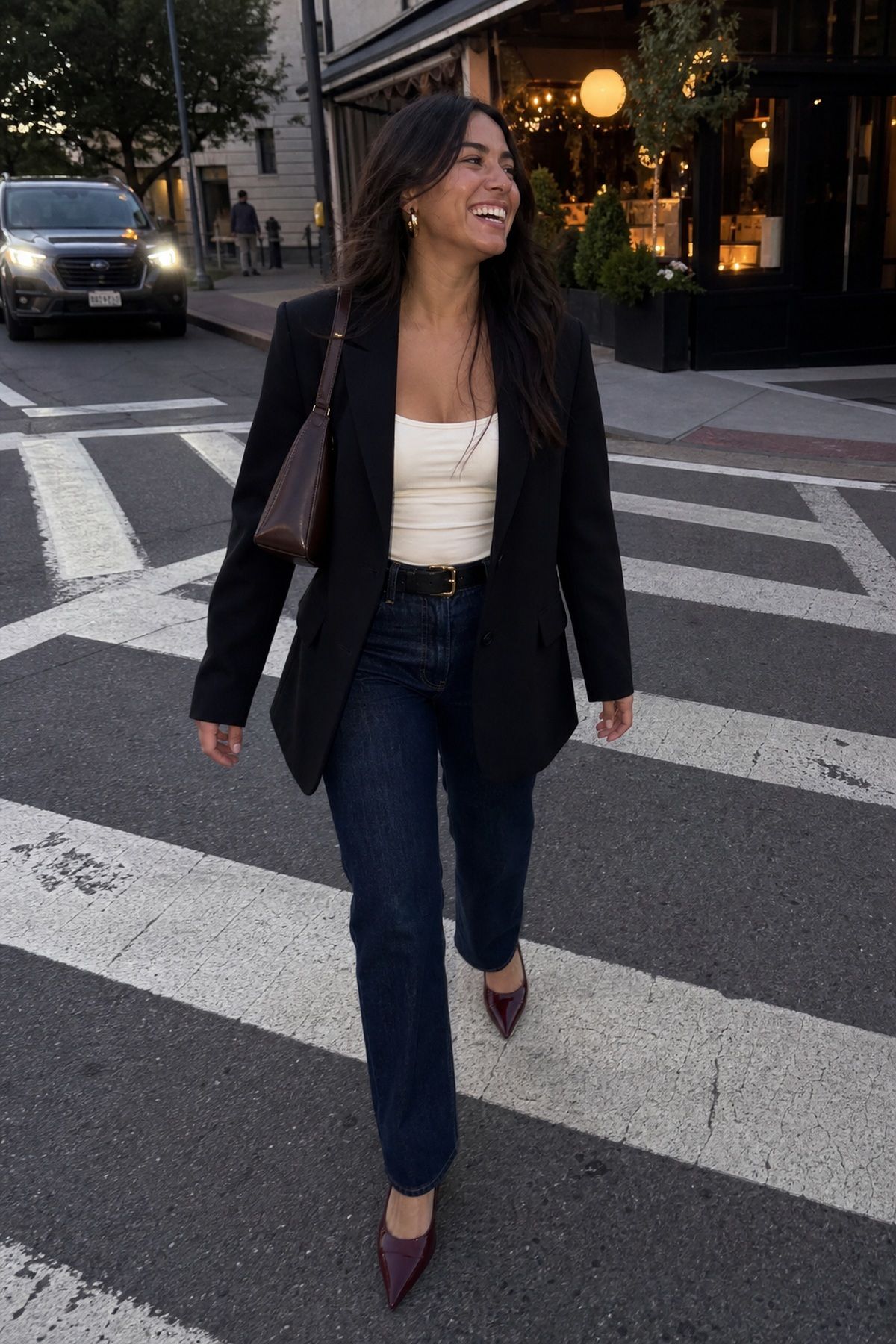 Woman wearing dark-wash straight-leg jeans with heels and a blazer, a fall date night outfit