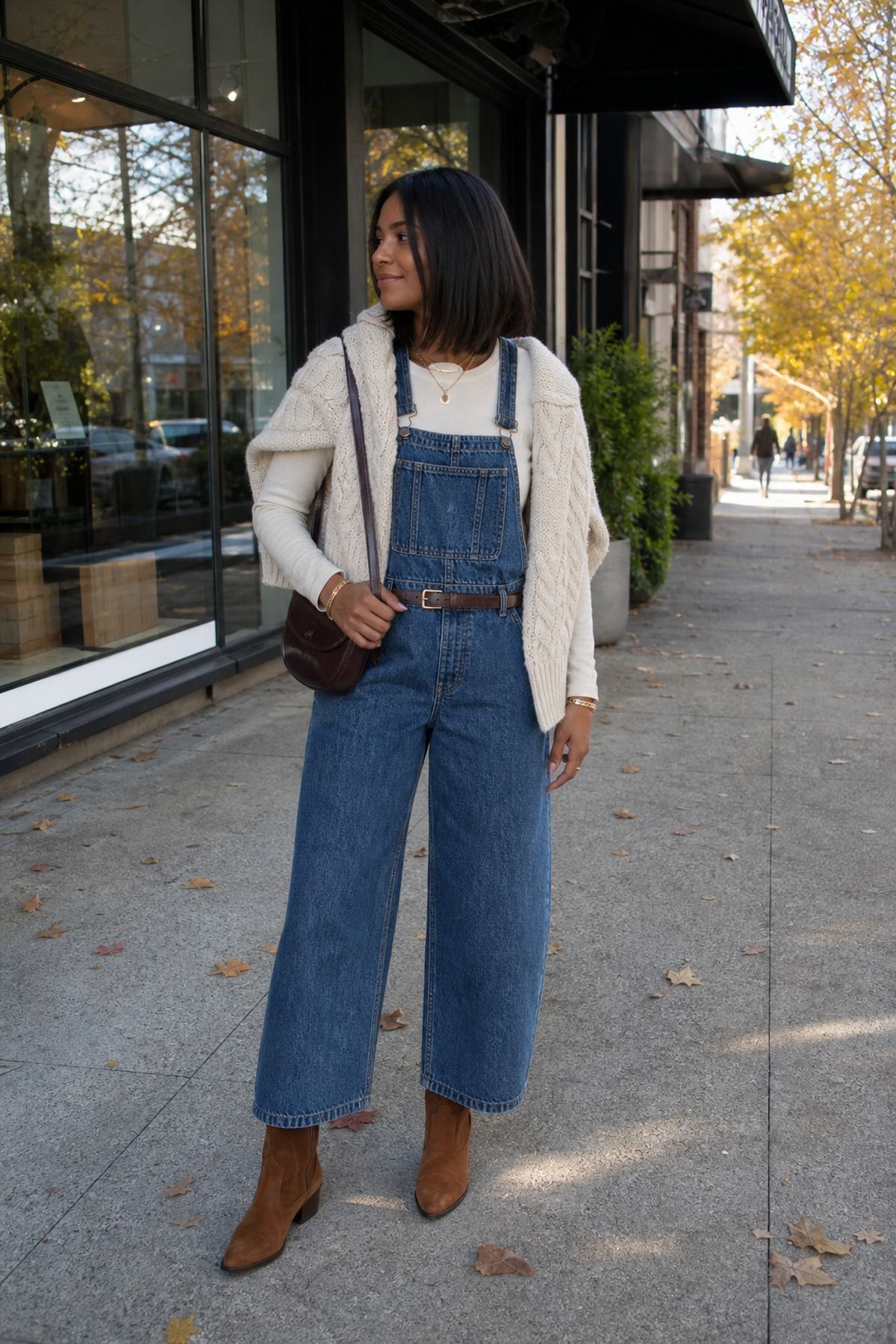 Denim Overalls With a Cream Long-Sleeve and Chunky Knit outfit idea for 10 Best Fall Overalls Outfit Ideas That Make Layering Look Easy.
