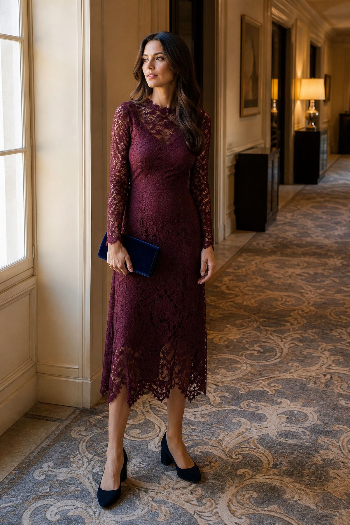 Woman wearing a long-sleeve lace midi dress in burgundy or navy, a fall wedding guest outfit