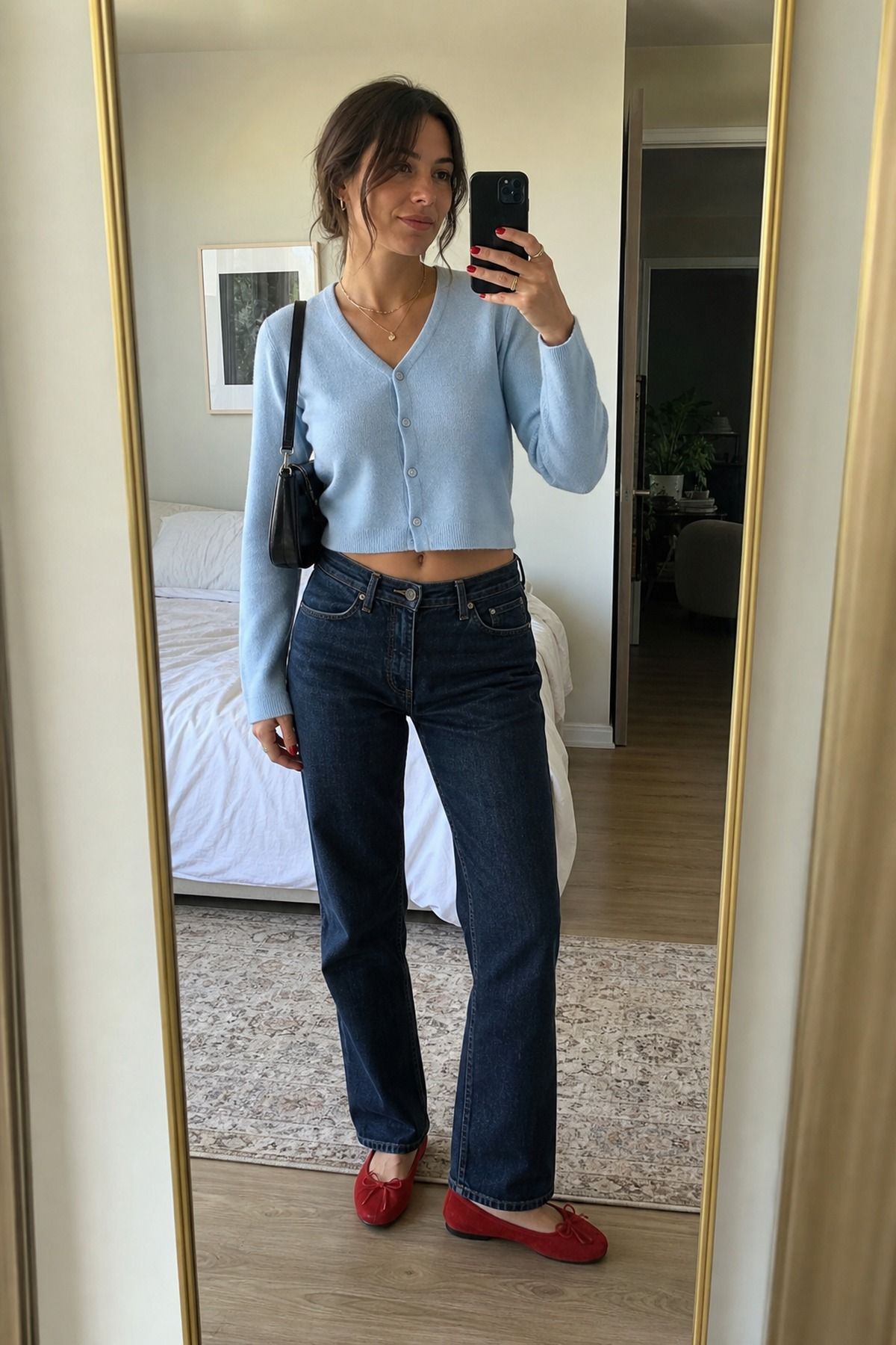 Woman wearing a cardigan + denim + ballet flats