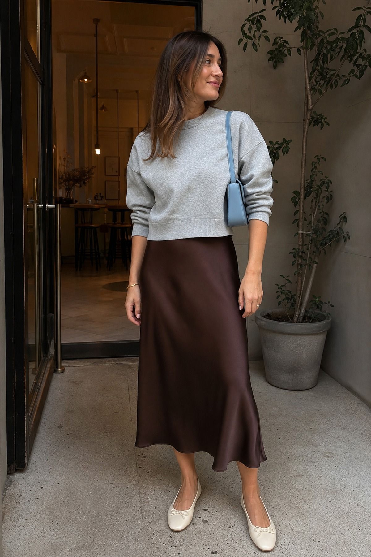 Woman wearing a slip skirt + sweatshirt
