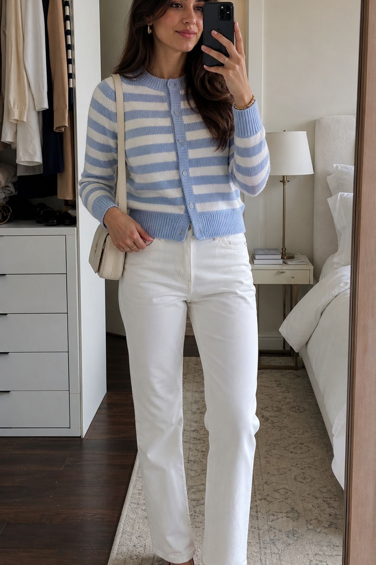 Woman wearing a striped cardigan with white jeans, a spring brunch outfit
