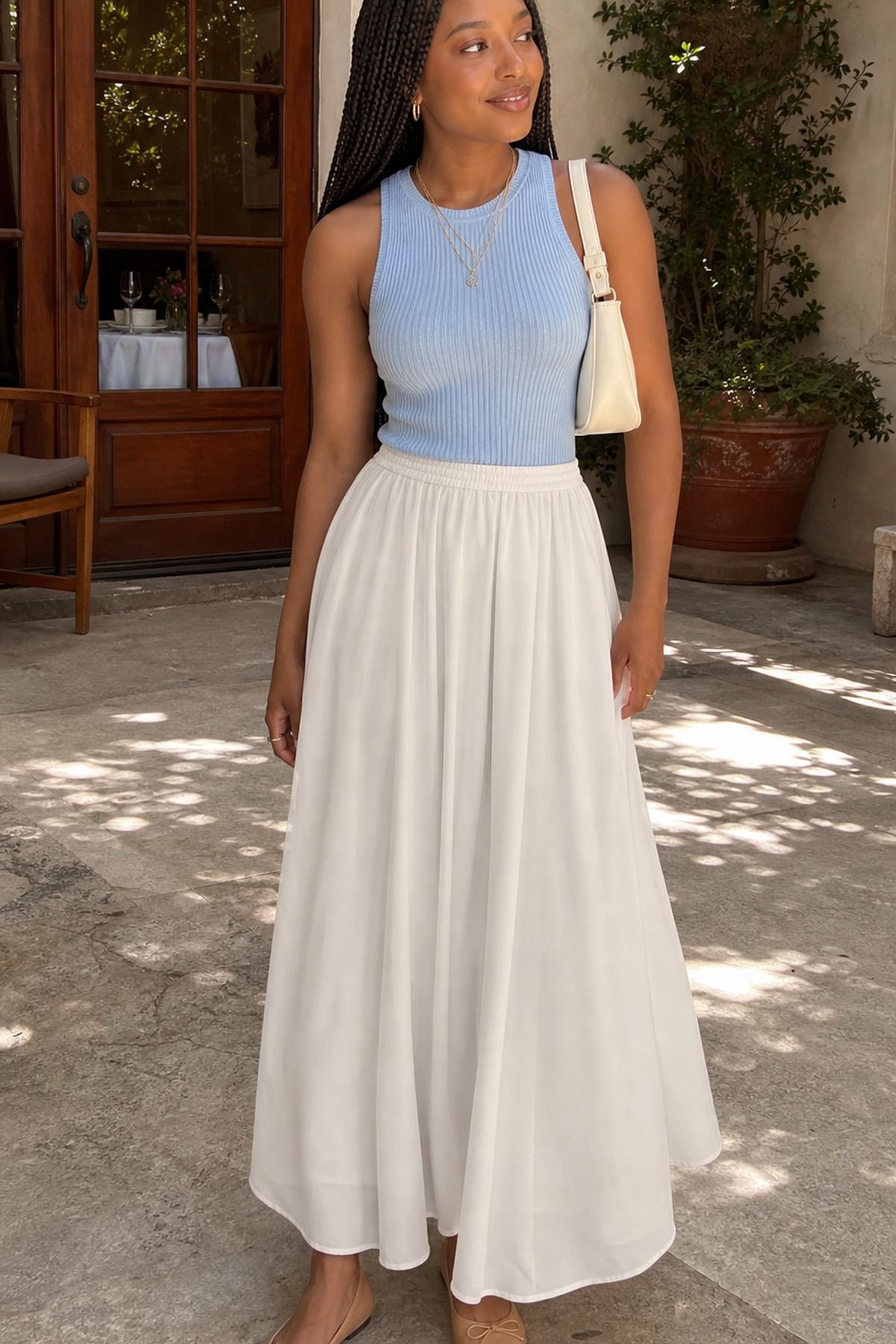 Woman wearing a sleeveless knit top with a flowy maxi skirt, a spring brunch outfit