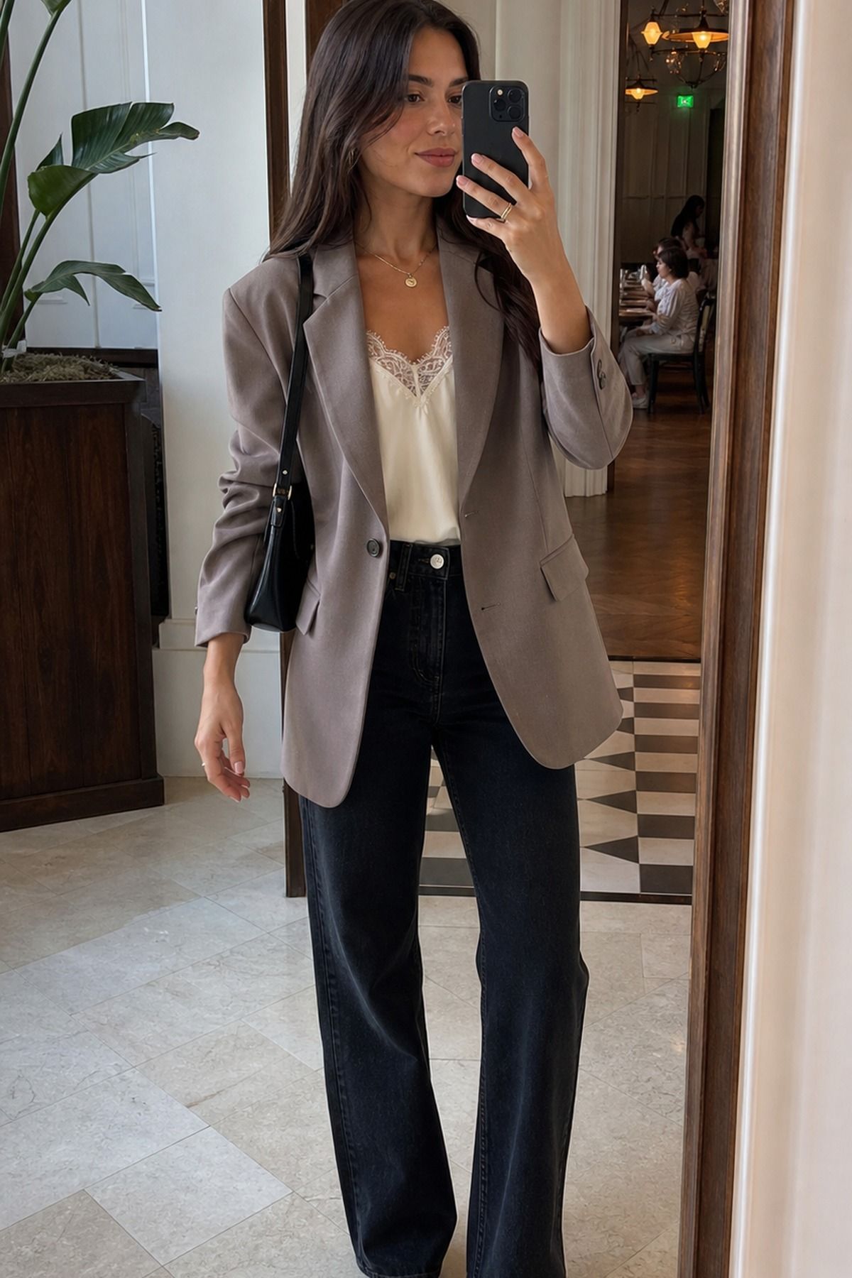 Woman wearing a relaxed blazer with a lace-trim cami, a spring brunch outfit