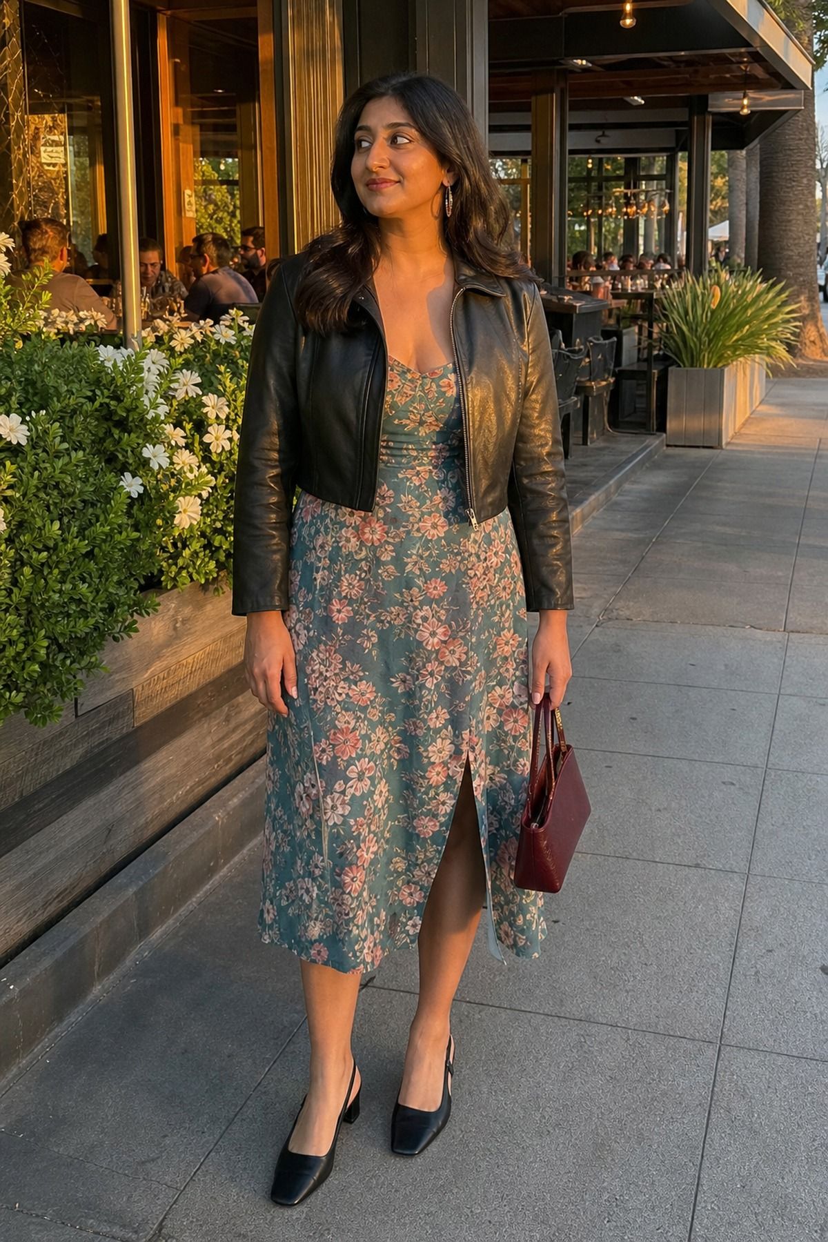 Woman wearing a leather jacket with a floral midi dress, a spring date night outfit