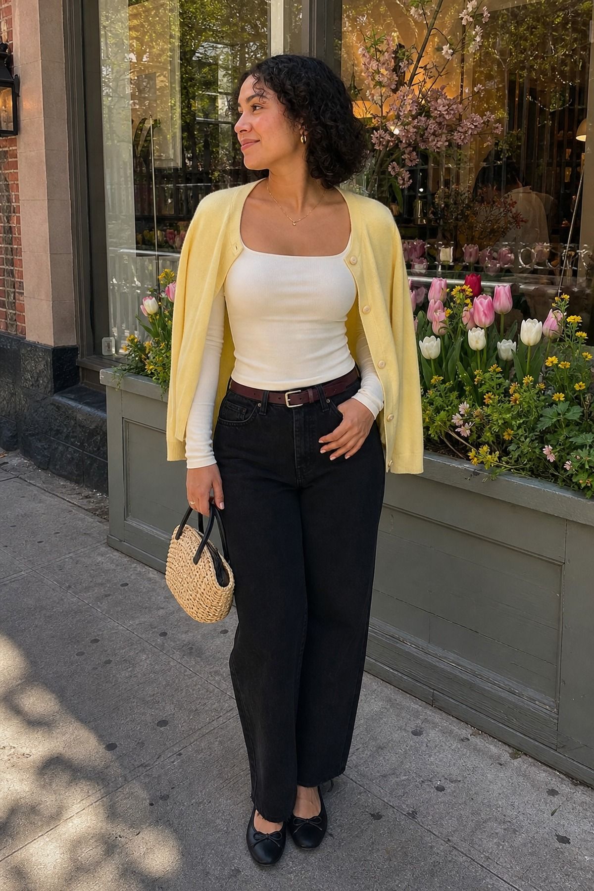 Woman wearing a square-neck top with relaxed black jeans, a spring date night outfit