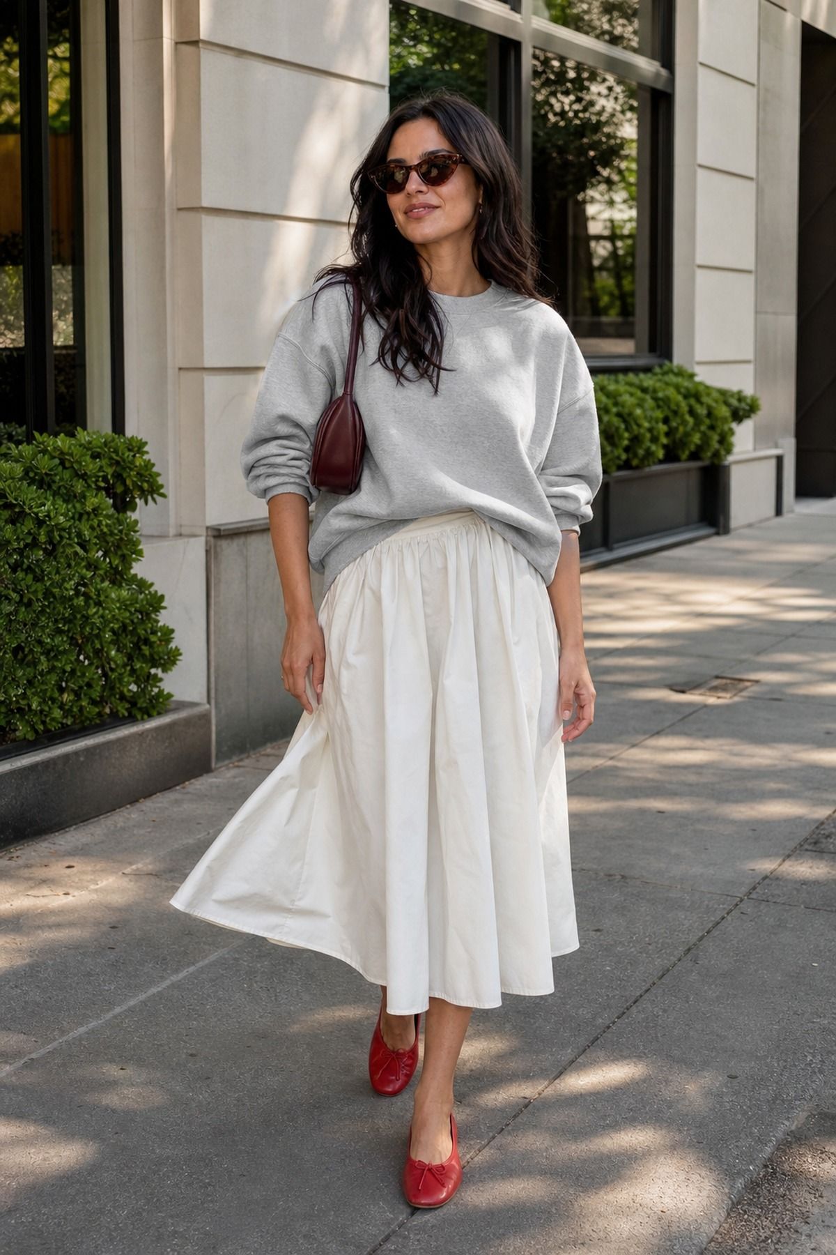 Woman wearing a sweatshirt with a midi skirt