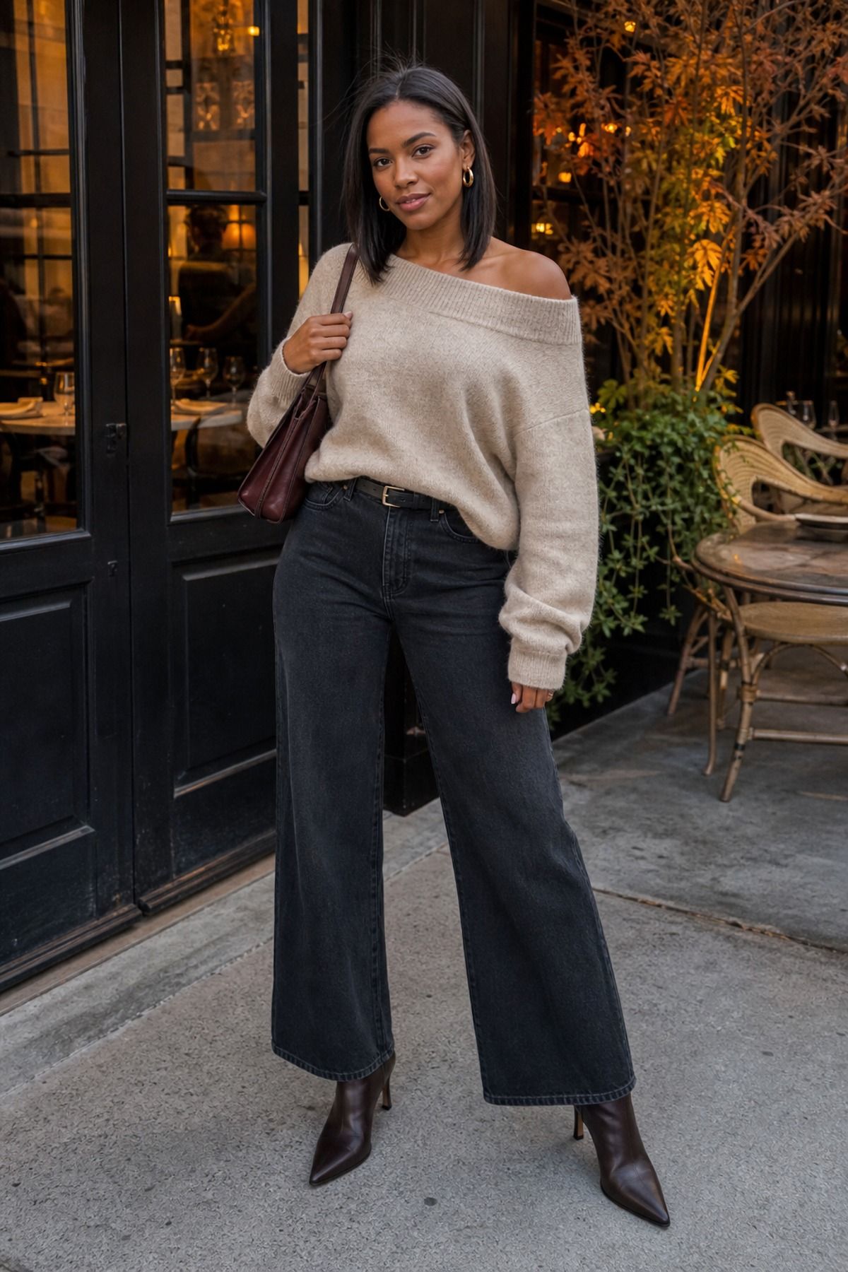 Woman wearing an off-shoulder sweater with wide-leg jeans and heeled boots