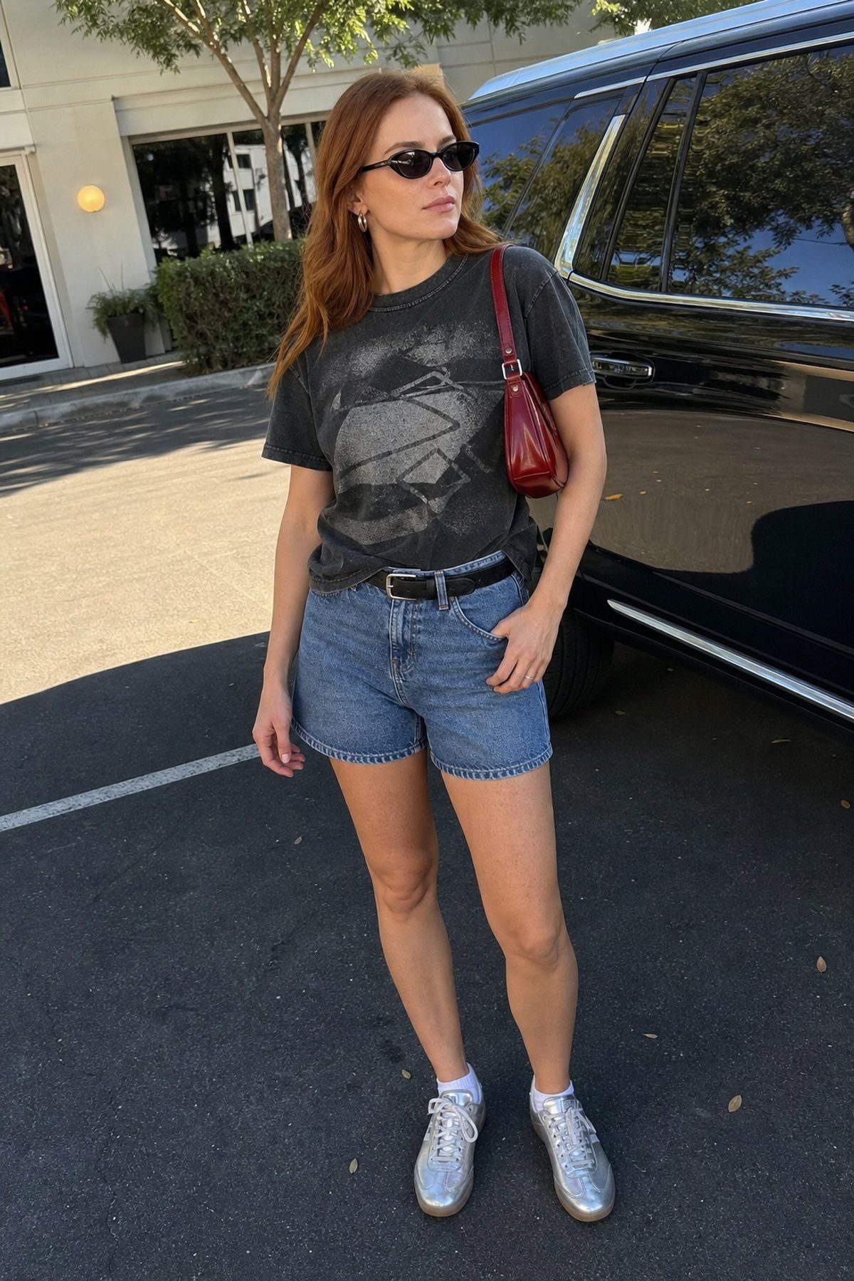 Woman wearing denim shorts with a graphic tee