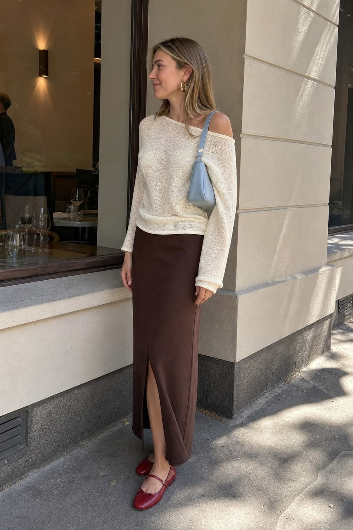 Woman wearing a column skirt with an off-shoulder sweater, a spring dinner outfit