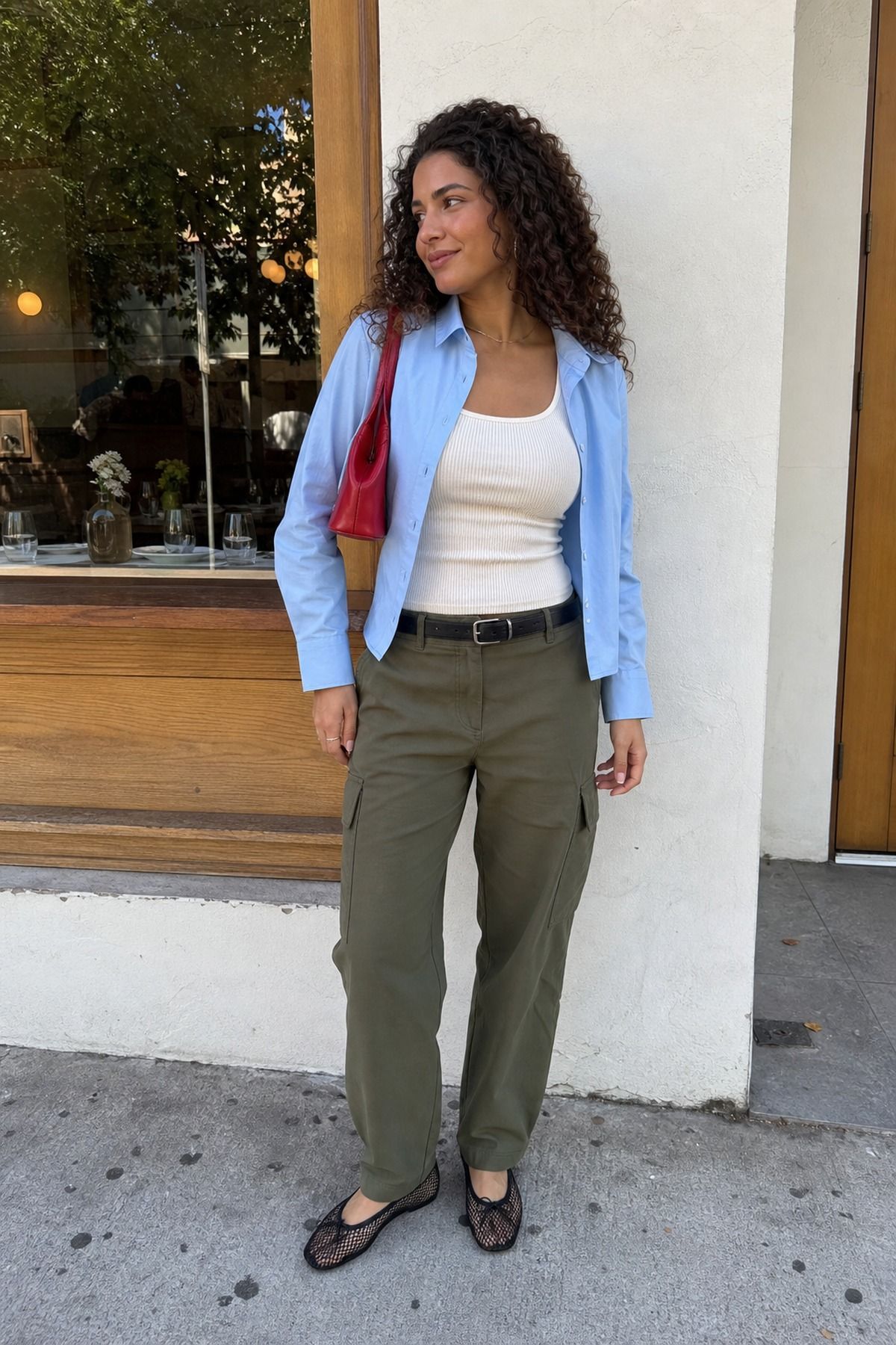 Woman wearing soft cargo pants with a fitted tank, a spring dinner outfit