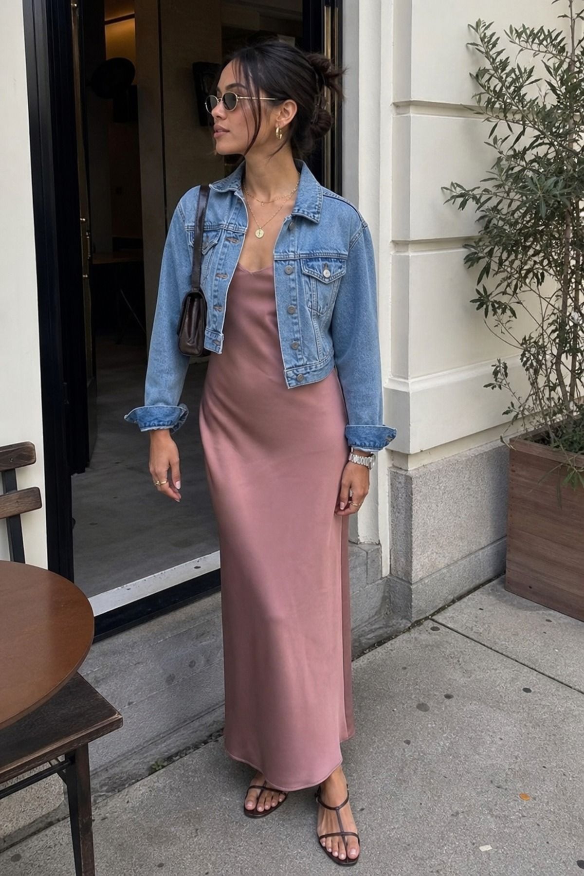 Woman wearing a cropped denim jacket with a column dress, a spring jacket outfit