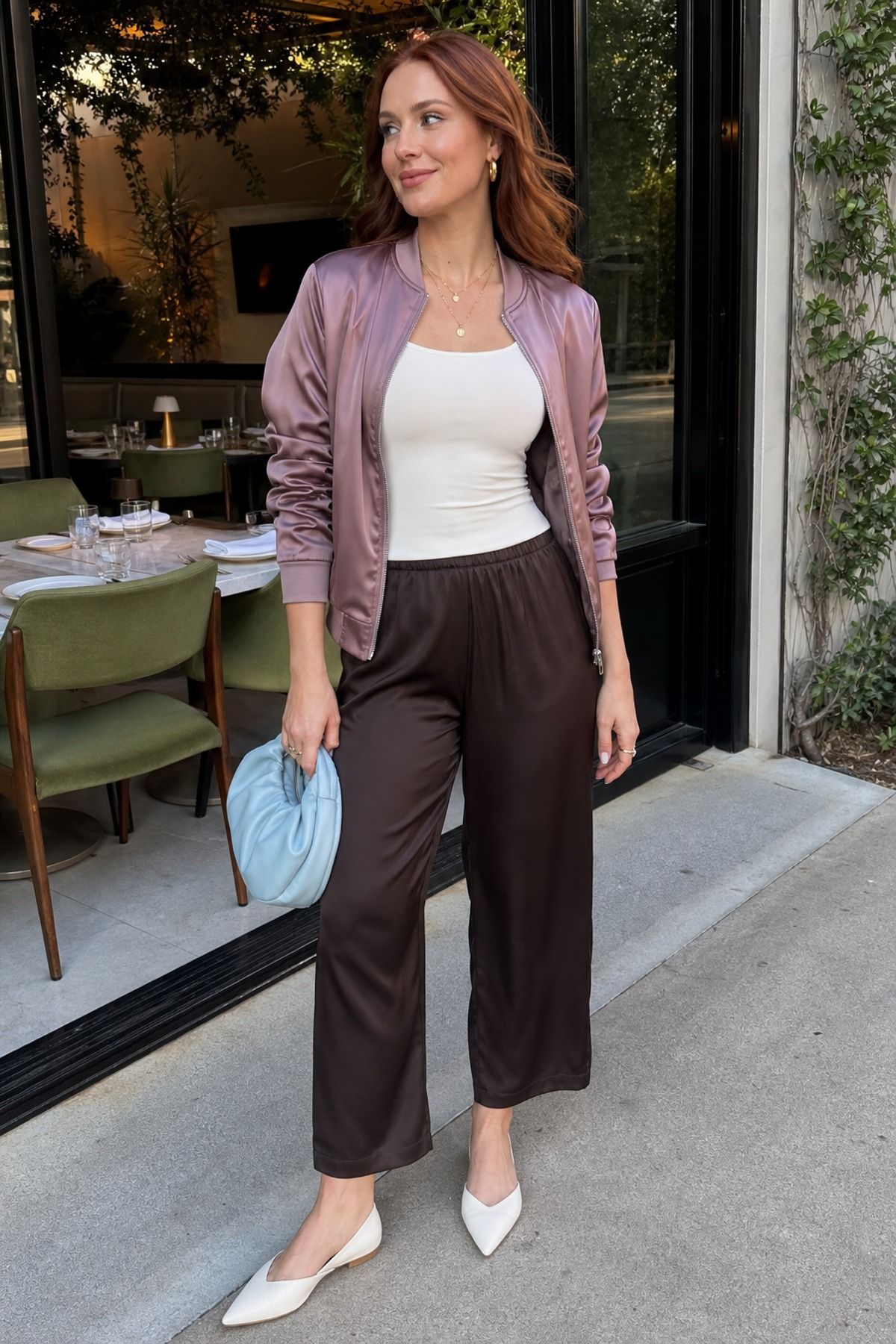 Woman wearing a satin bomber with a tank and slip-on pants, a spring jacket outfit