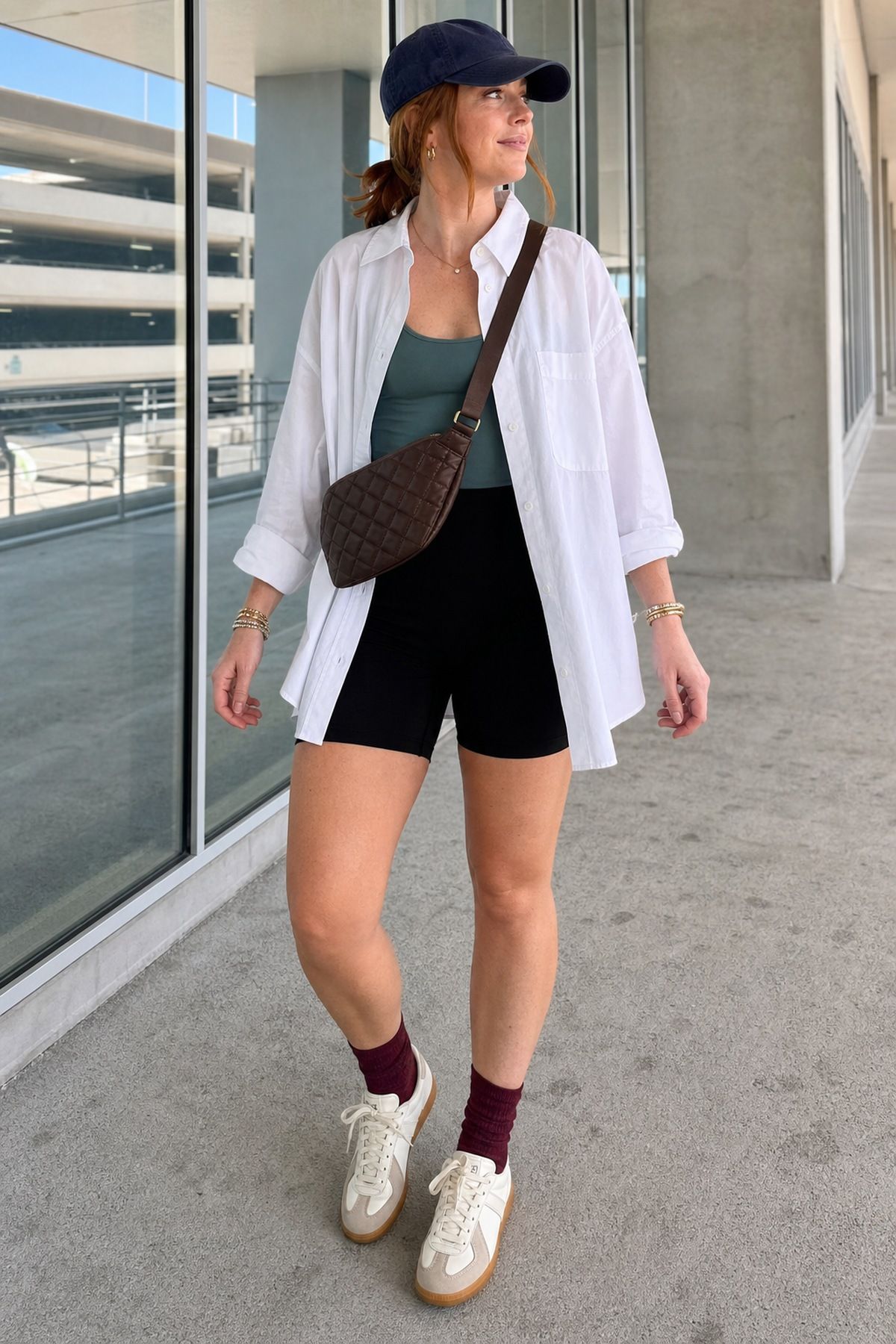 Woman wearing a button down with bike shorts, a summer airport outfit