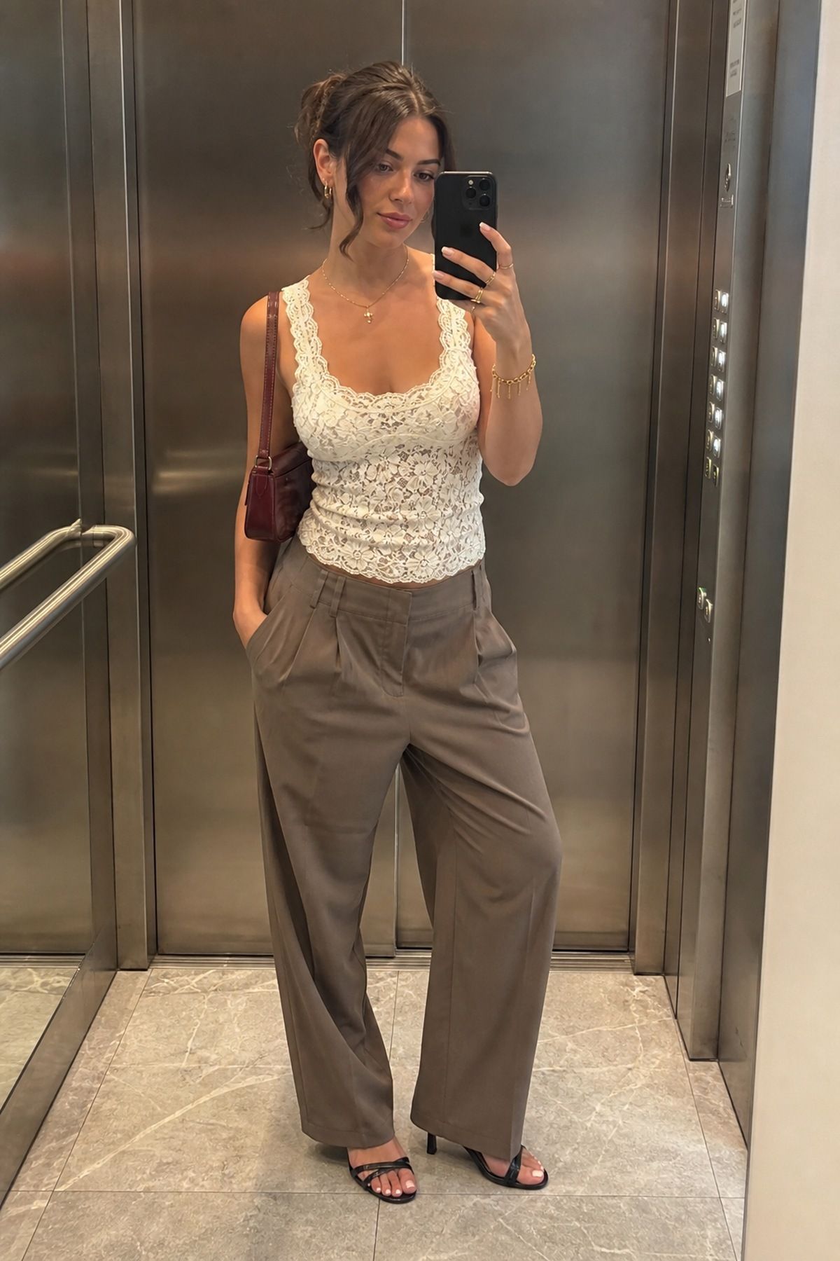 Woman wearing soft trousers with a lace tank, a summer date night outfit