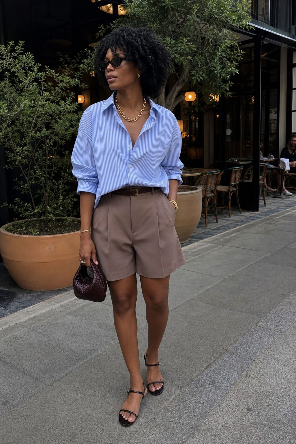 Woman wearing tailored shorts with a button down, a summer dinner outfit