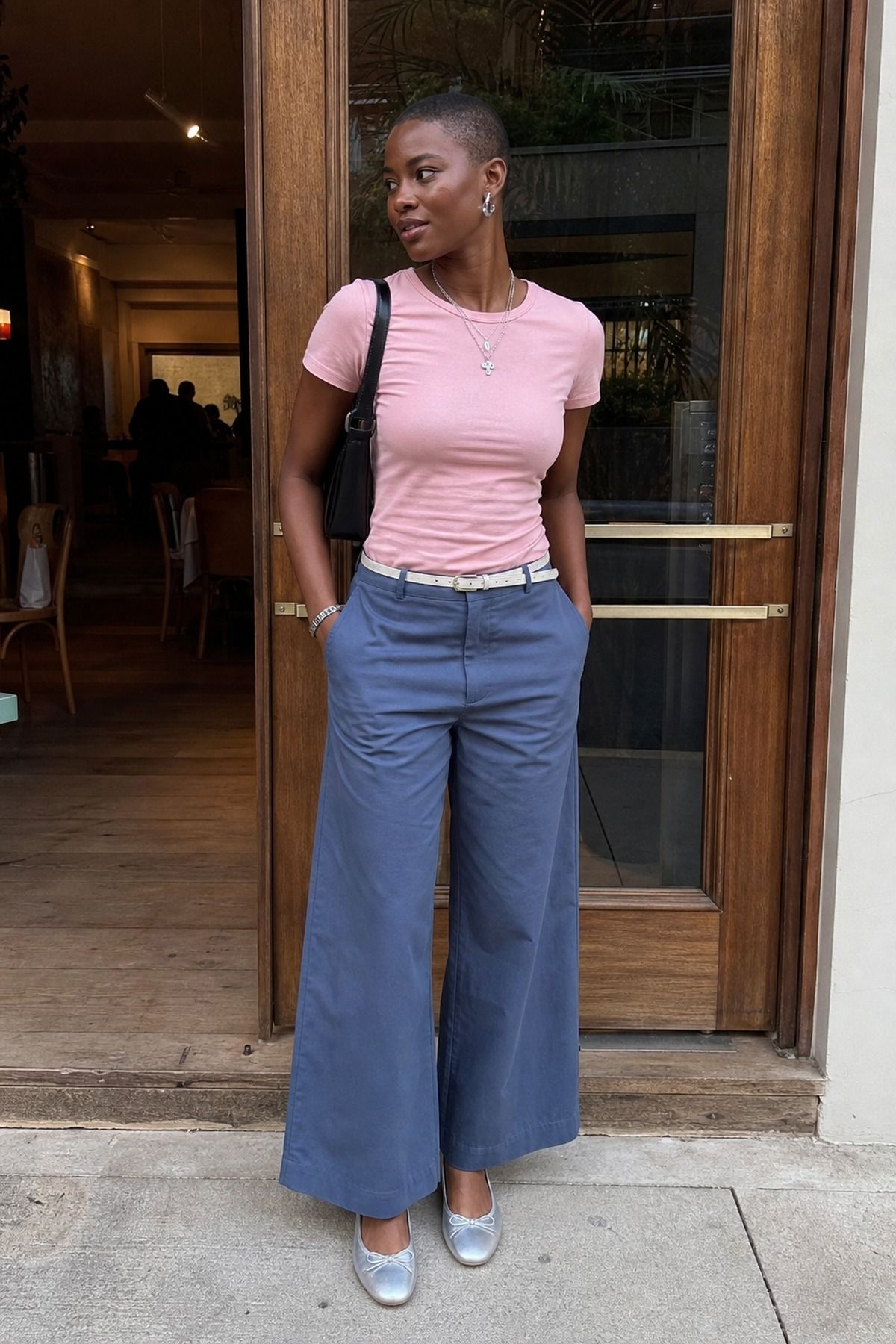 Woman wearing lightweight trousers with a baby tee, a summer dinner outfit