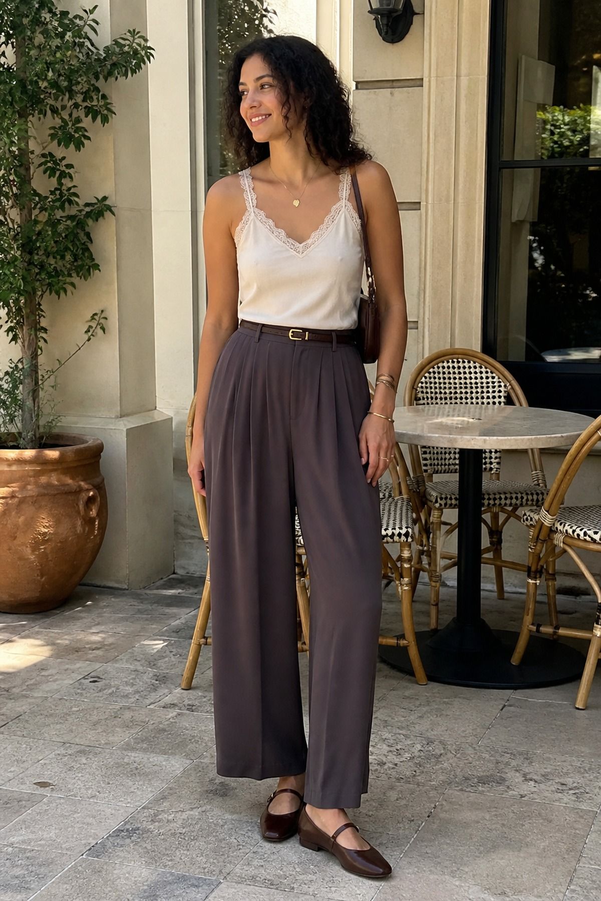 Woman wearing soft trousers with a lace tank, a summer travel outfit