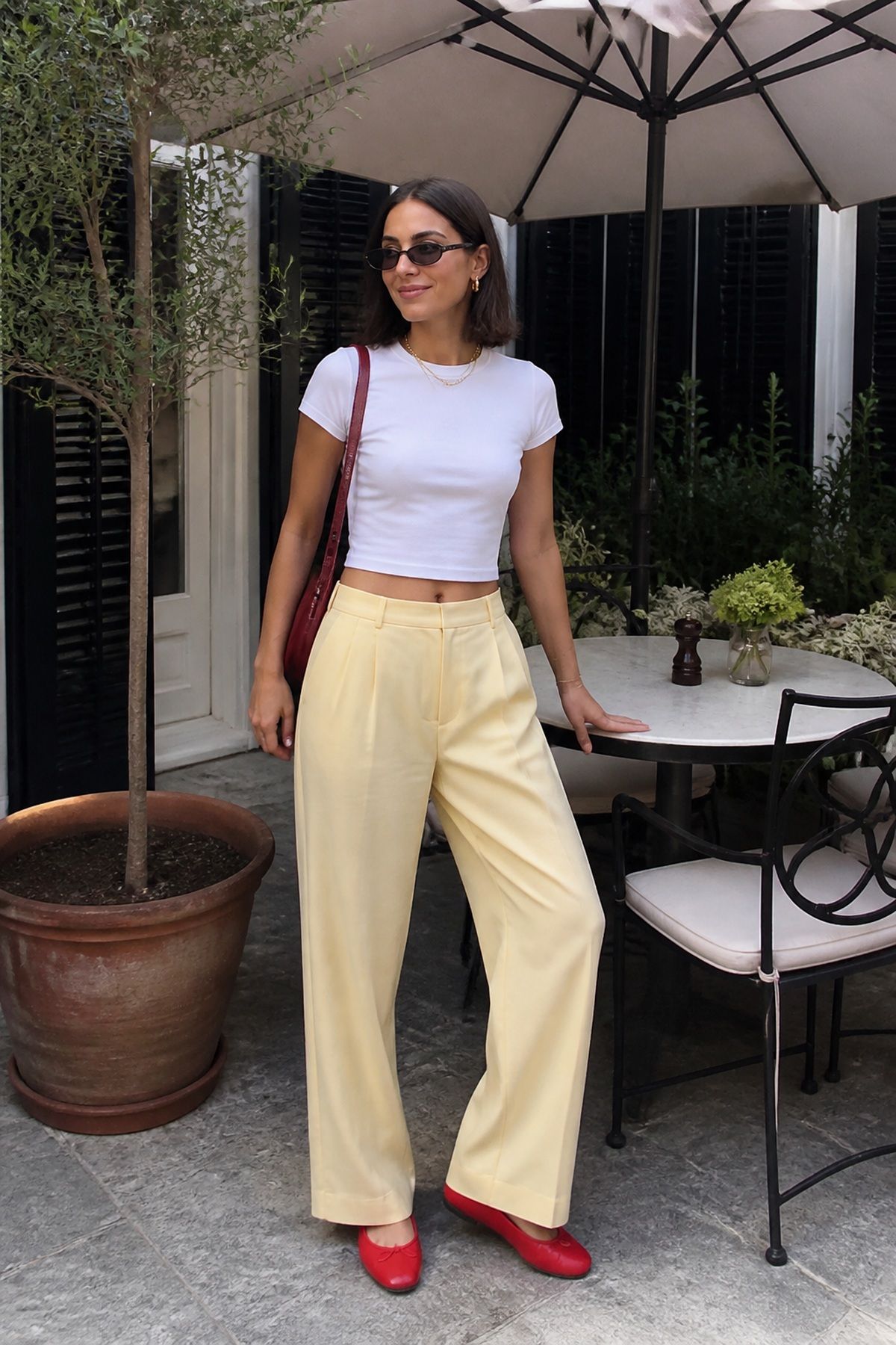 Woman wearing lightweight trousers with a baby tee, a summer vacation outfit