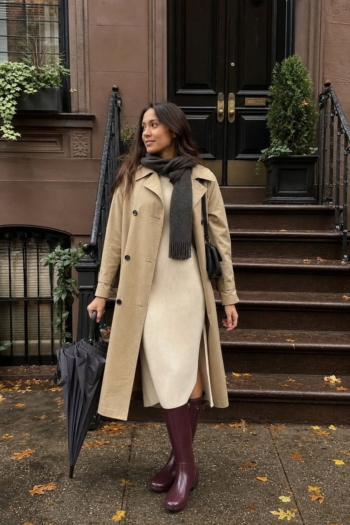 Woman wearing a trench with a knit dress, a fall rainy day outfit