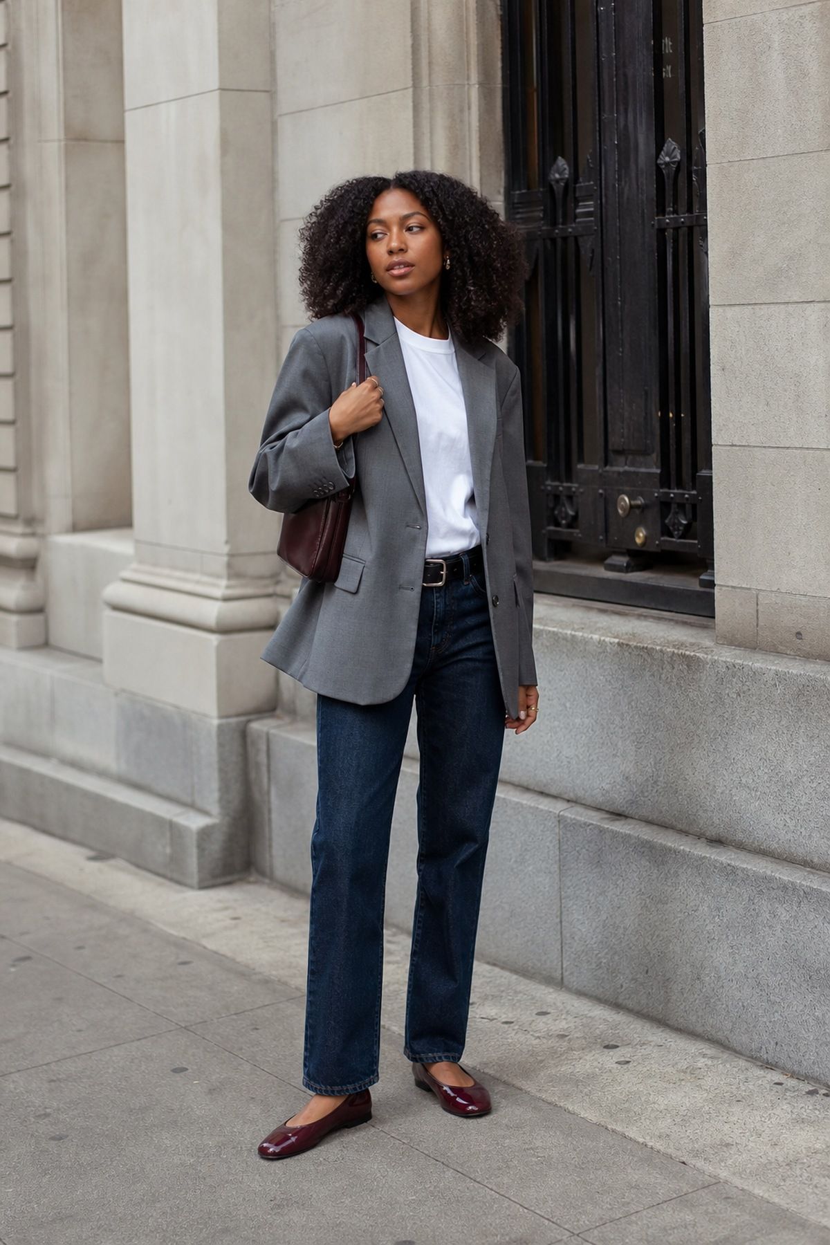 Woman wearing a gray blazer with dark denim