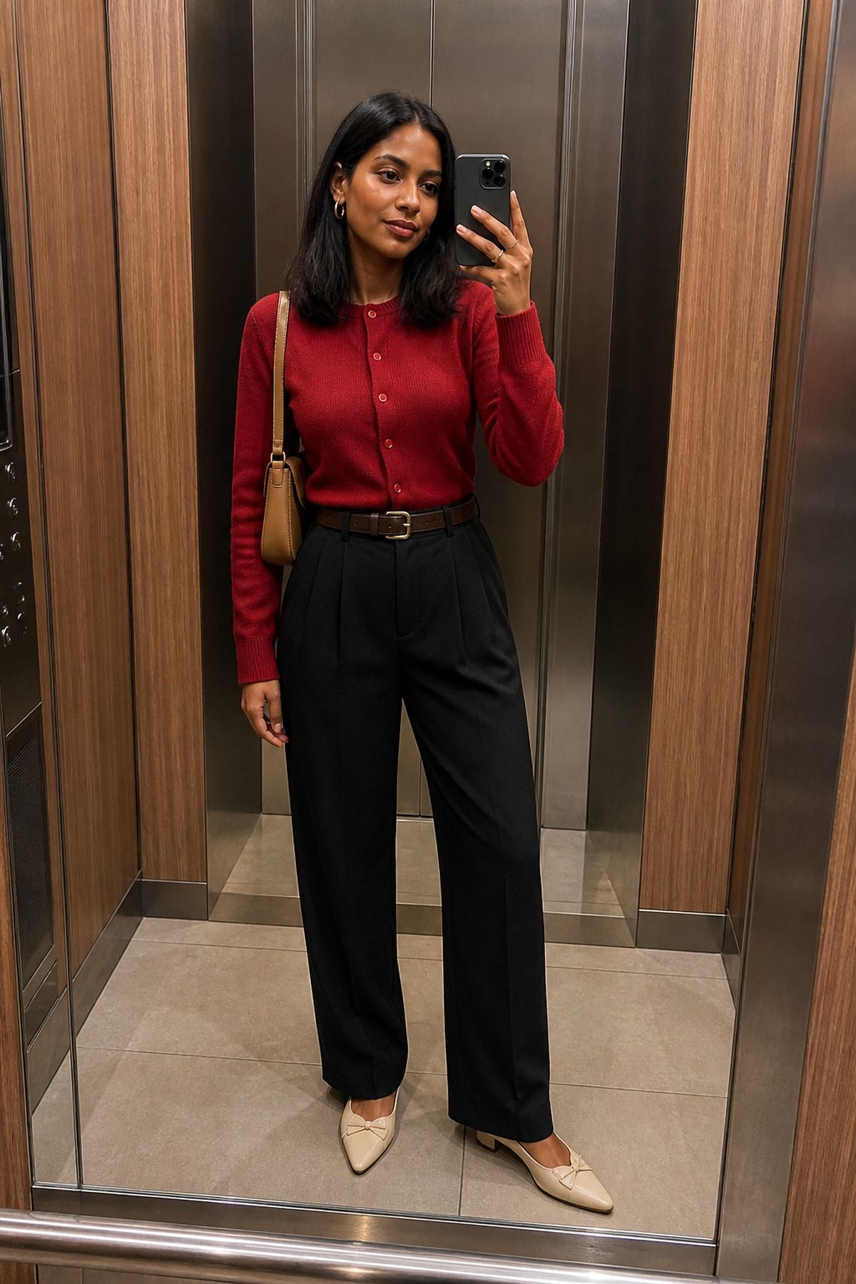 Woman wearing a red cardigan with black trousers, a fall dinner outfit
