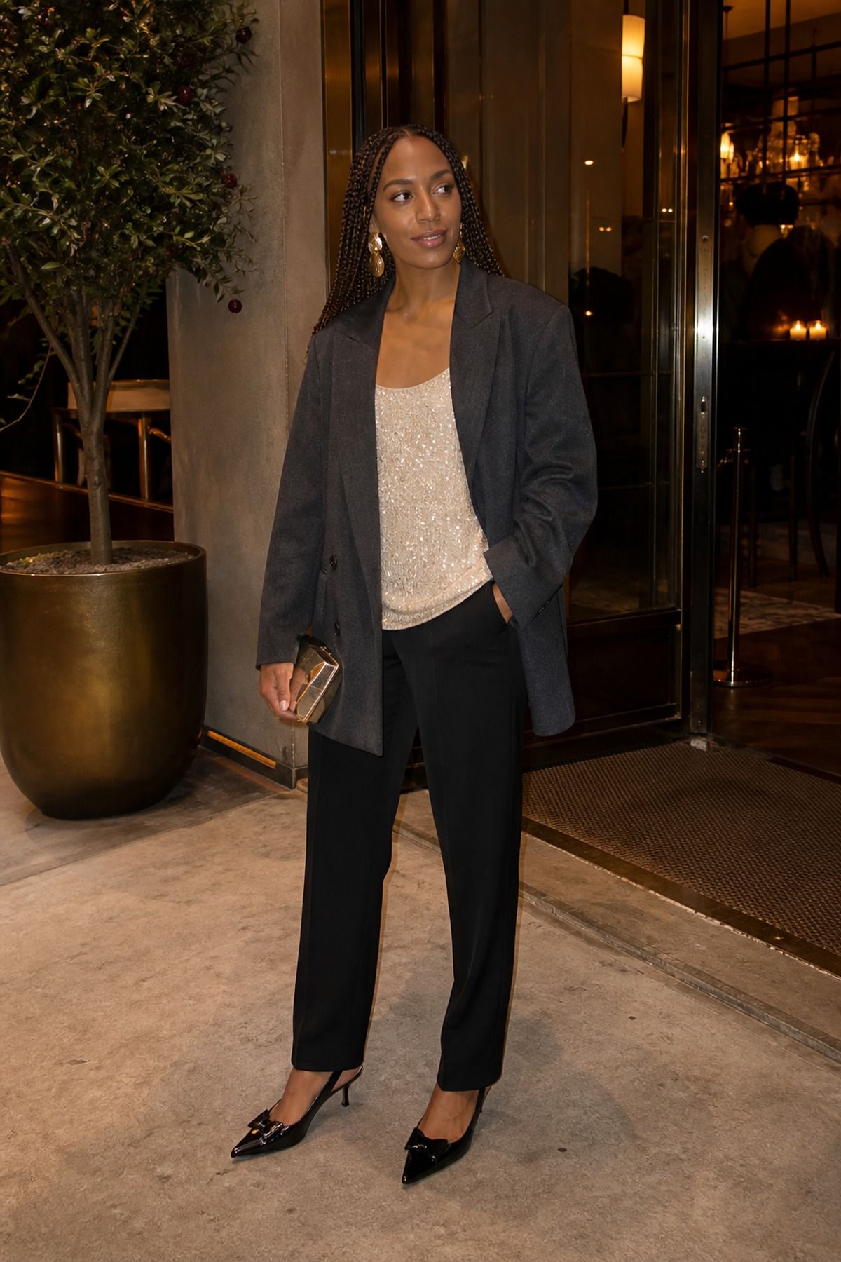 Woman wearing a sequin tank under a wool blazer, a fall dinner outfit
