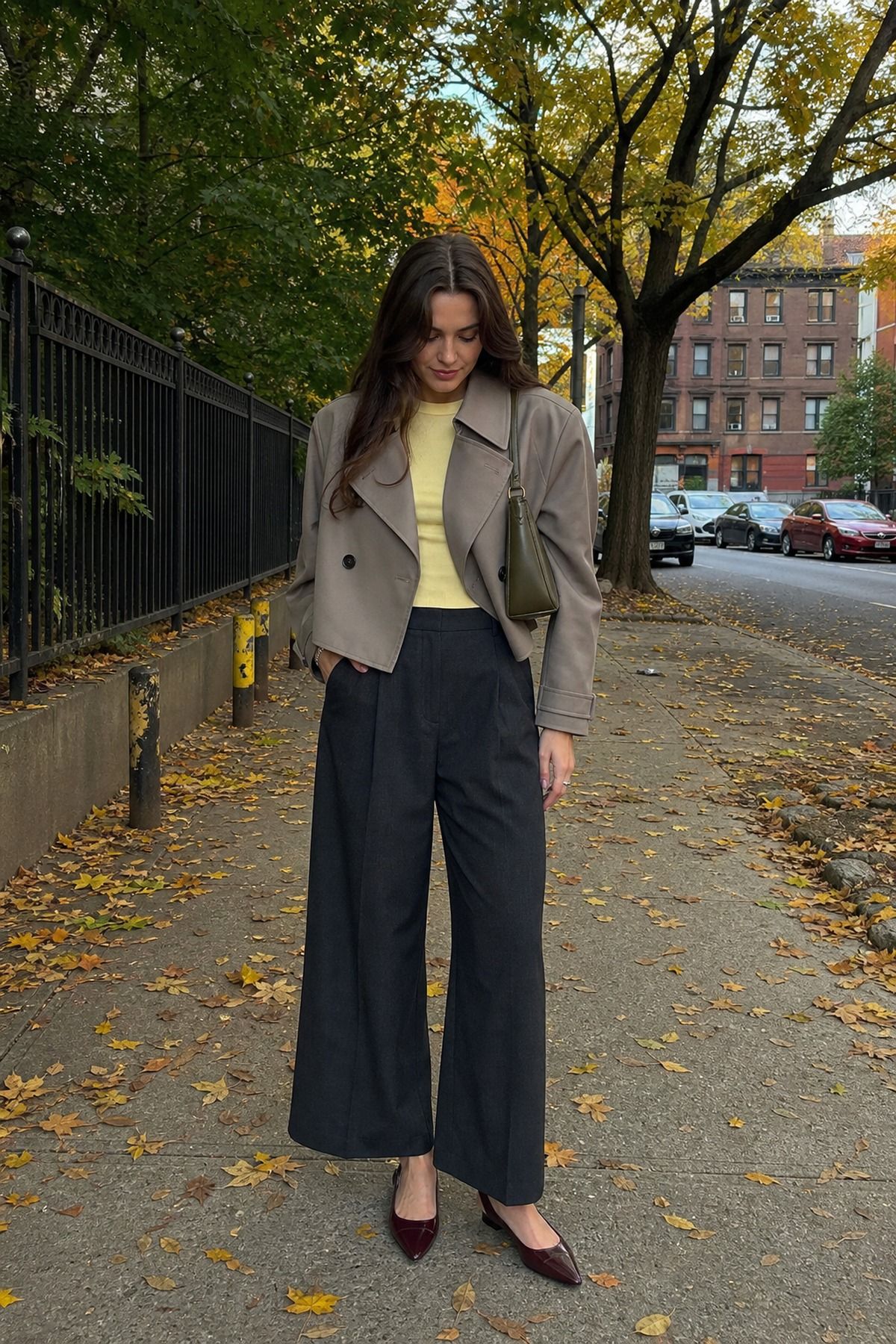 Woman wearing a short trench with wide-leg pants, a fall trench coat outfit