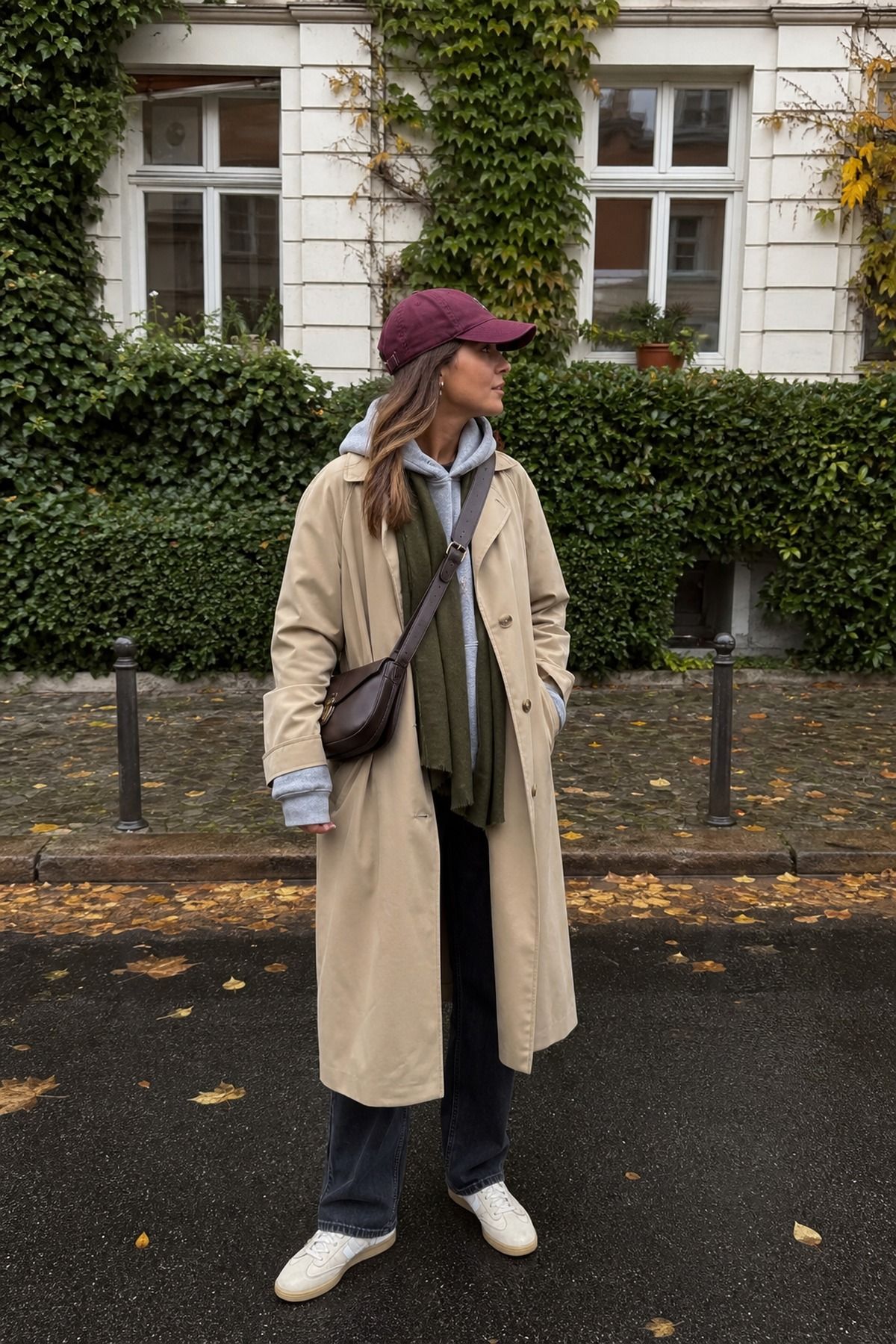 Woman wearing a trench over a hoodie, a fall trench coat outfit