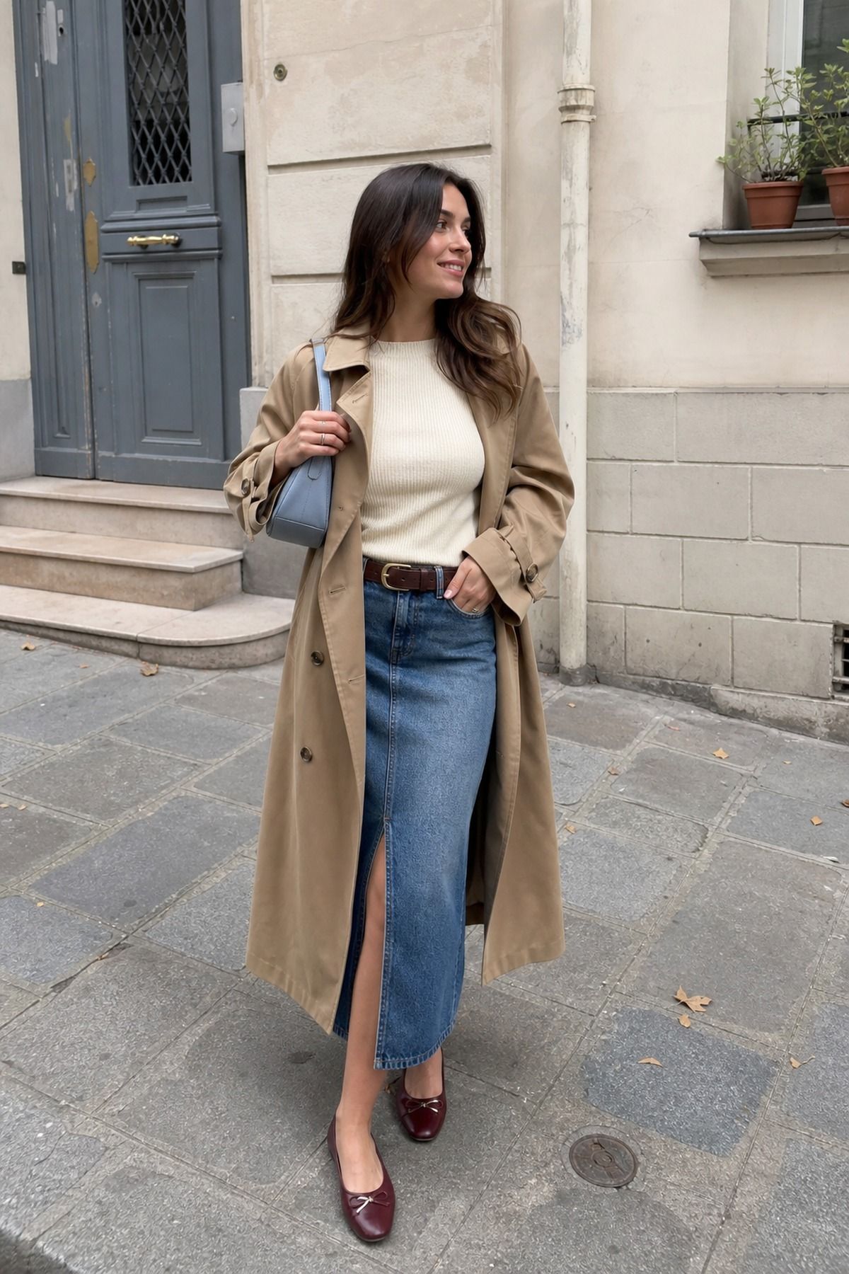 Woman wearing a trench with a denim midi skirt, a fall trench coat outfit