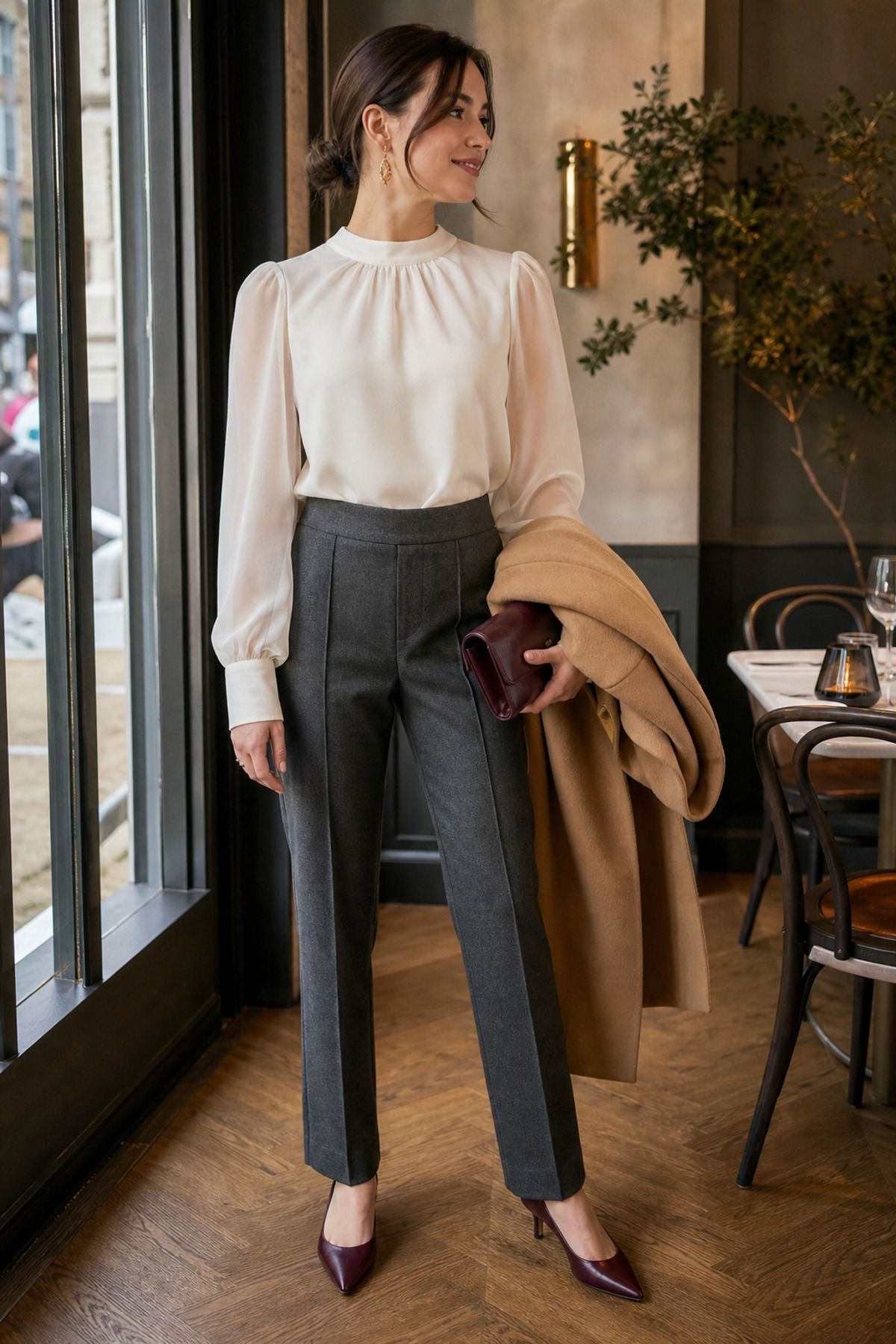 Woman wearing a sheer sleeve blouse with wool pants, a winter date night outfit