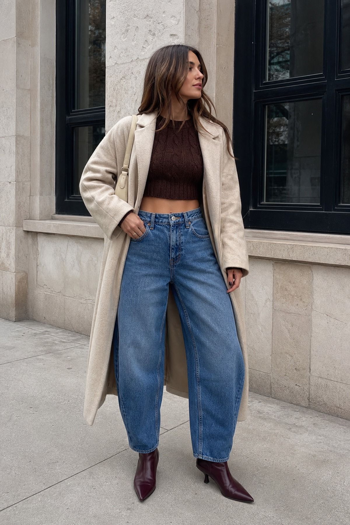 Woman wearing barrel jeans with a cropped sweater, a winter jeans outfit