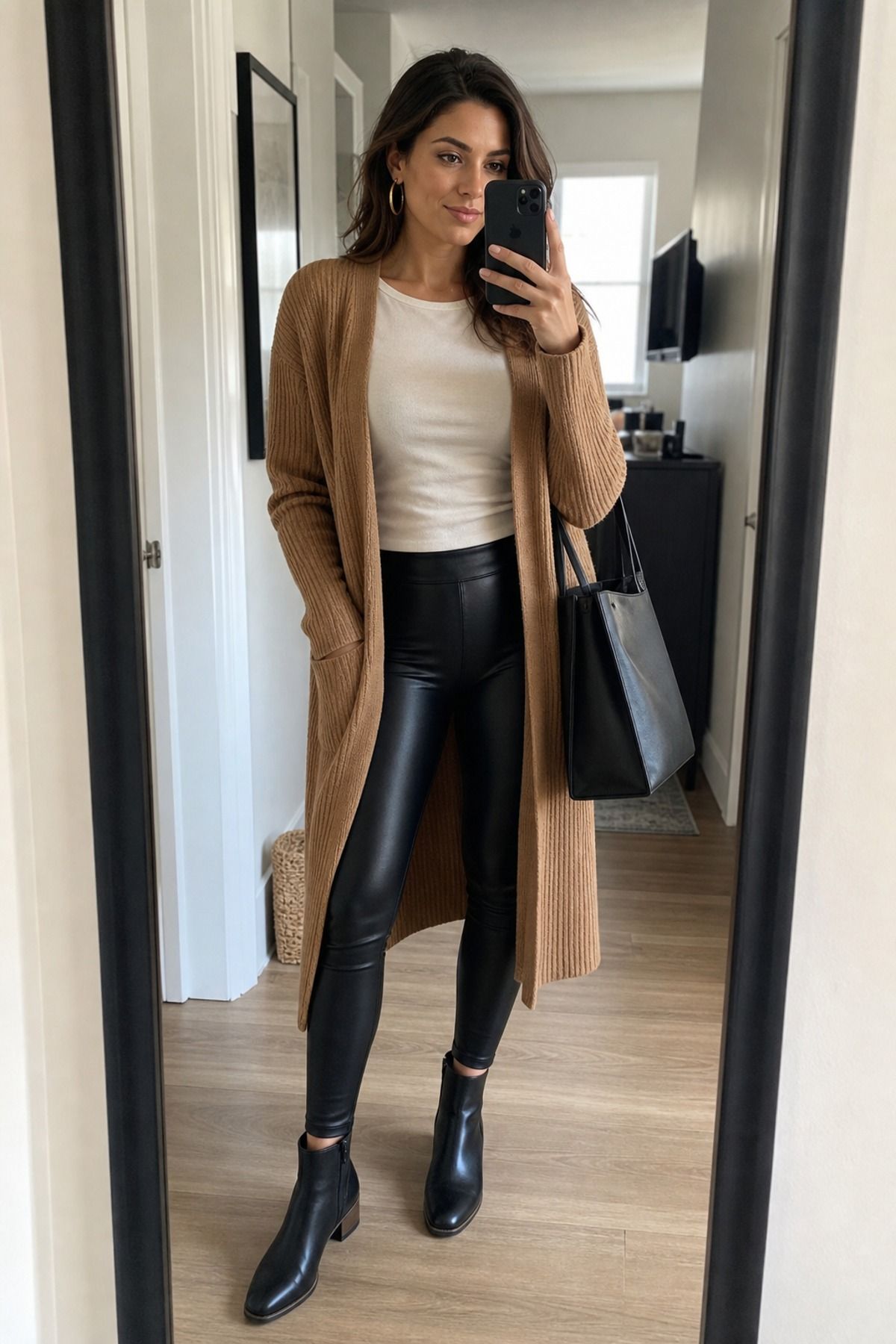 Woman wearing a long cardigan with leather leggings, a winter leggings outfit