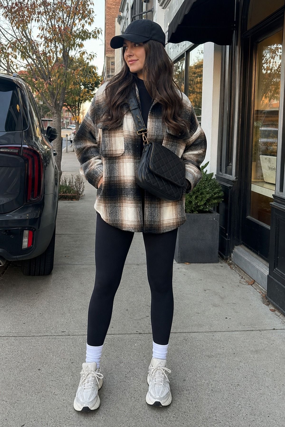 Woman wearing a shacket with black leggings, a 50 degree weather outfit