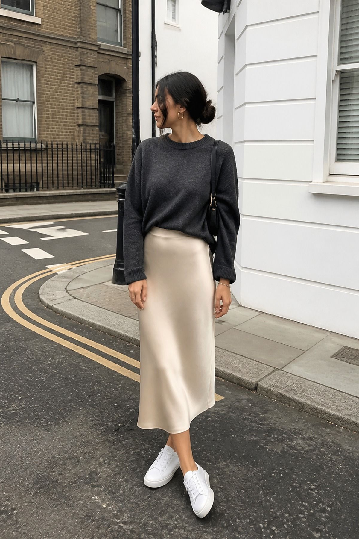Woman wearing a slip skirt with a crewneck sweater, a 60 degree weather outfit