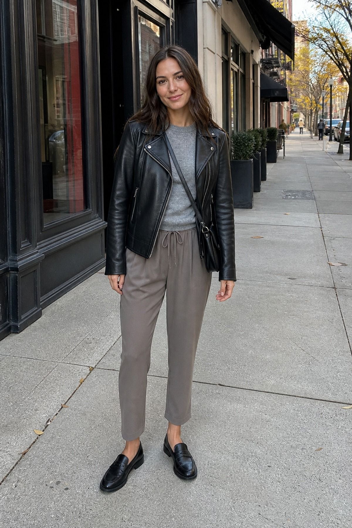 Woman wearing a leather jacket with soft trousers, a 60 degree weather outfit