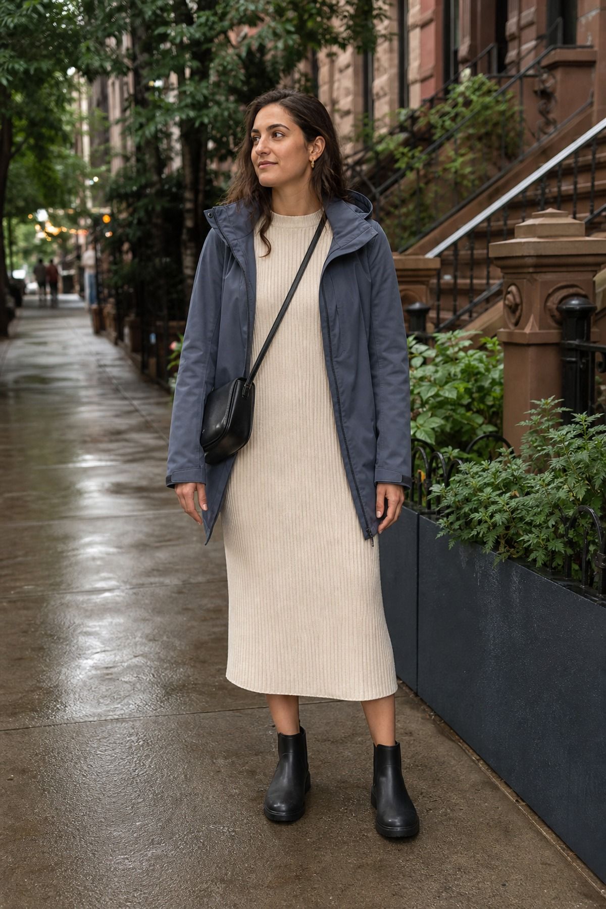 Woman wearing a rain shell with a knit dress, a 60 degree weather outfit