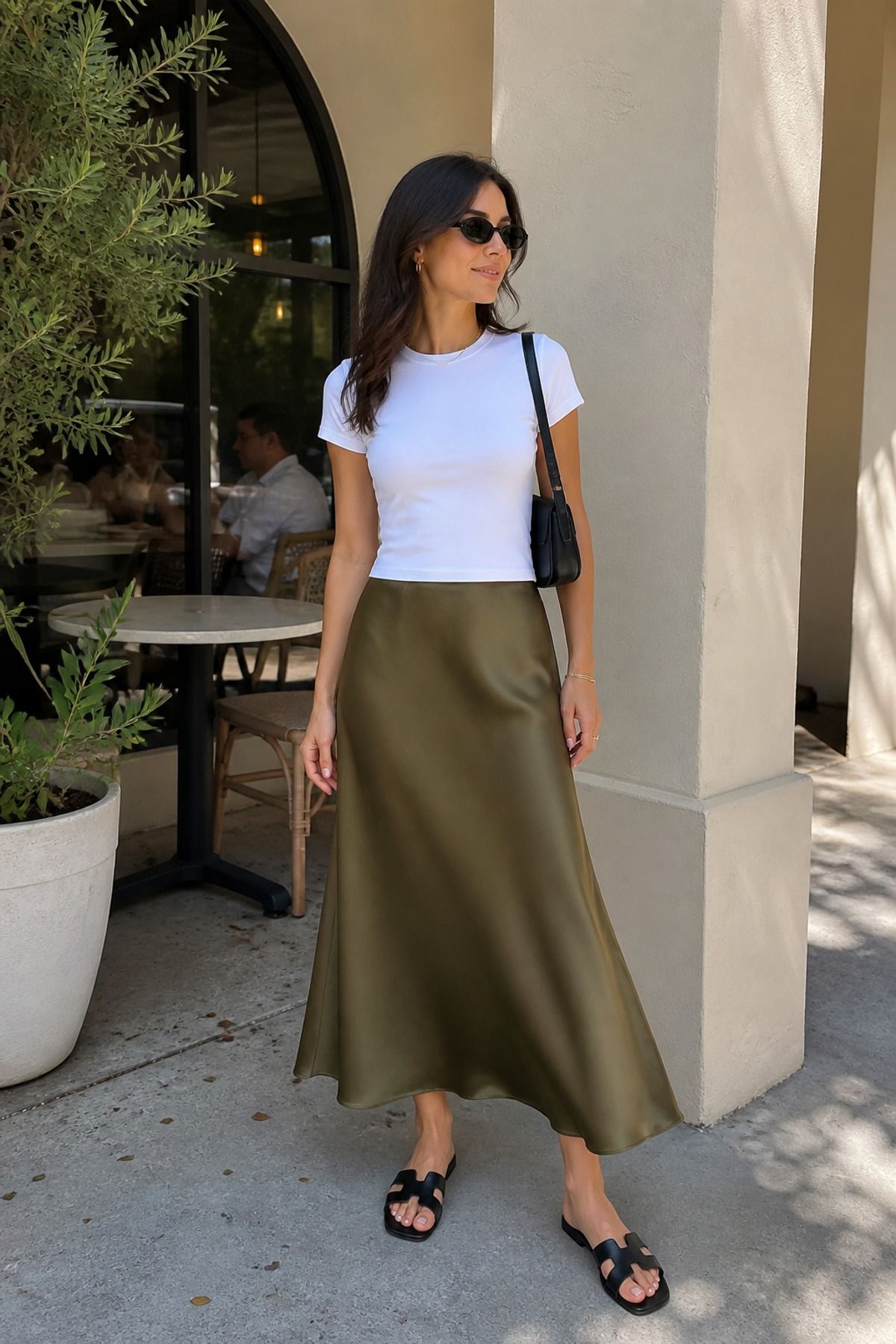 Woman wearing a slip skirt with a baby tee, a 70 degree weather outfit
