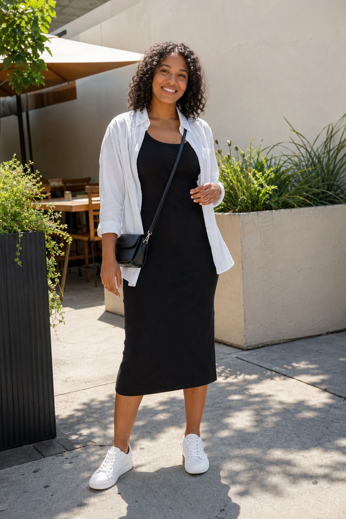 Woman wearing a tank dress with an open button down, a brunch outfit