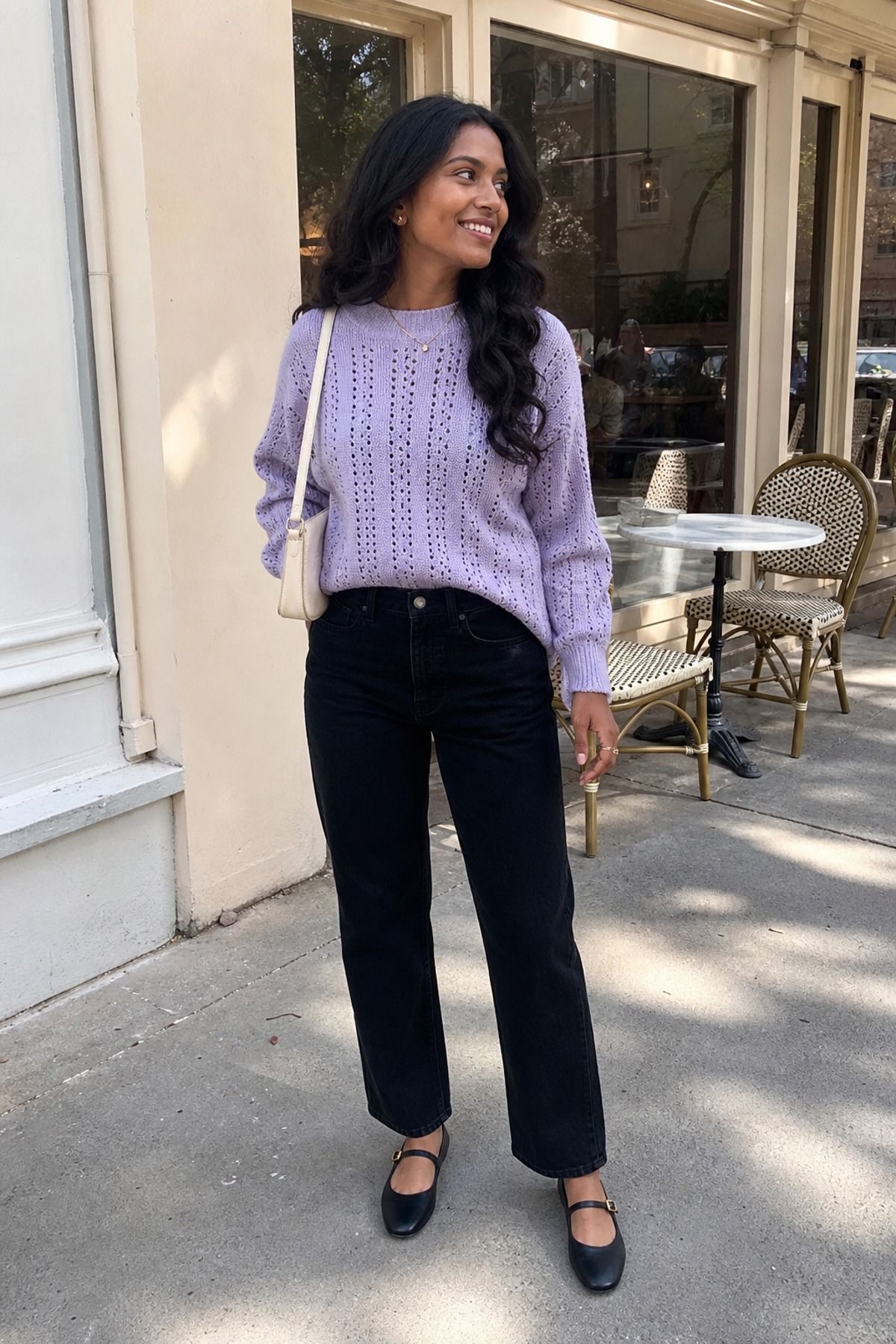 Woman wearing black jeans with a pretty knit, a coffee date outfit