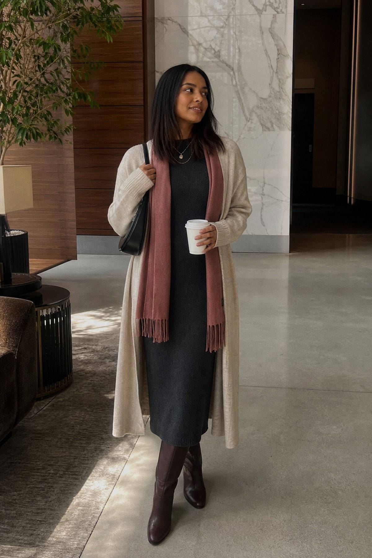 Woman wearing a long cardigan with a column dress, a cozy winter outfit